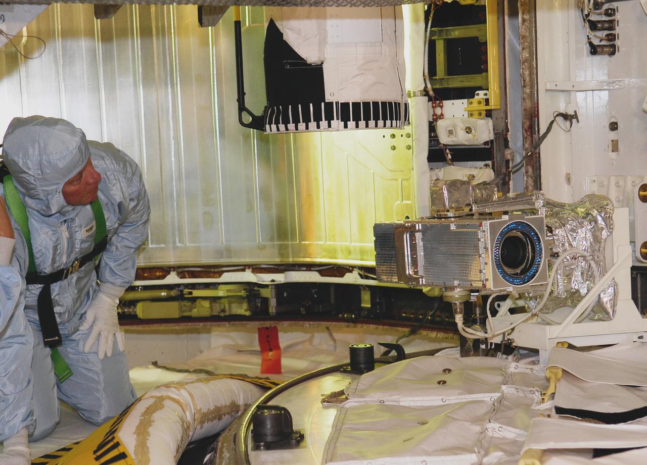 CAPE CANAVERAL, Fla. -- On Launch Pad 39A at NASA's Kennedy Space Center, STS-124 Mission Specialist Mike Fossum gets a close look the bottom of the Japanese Experiment Module – Pressurized Module in space shuttle Discovery's payload bay. The payload bay walkdown is part of the launch dress rehearsal called the terminal countdown demonstration test. TCDT provides astronauts and ground crews with an opportunity to participate in various simulated countdown activities, including equipment familiarization and emergency training. On the STS-124 mission, the crew will deliver and install the Japanese Experiment Module – Pressurized Module and Japanese Remote Manipulator System. Discovery's launch is targeted for May 31. Photo credit: NASA/Kim Shiflett