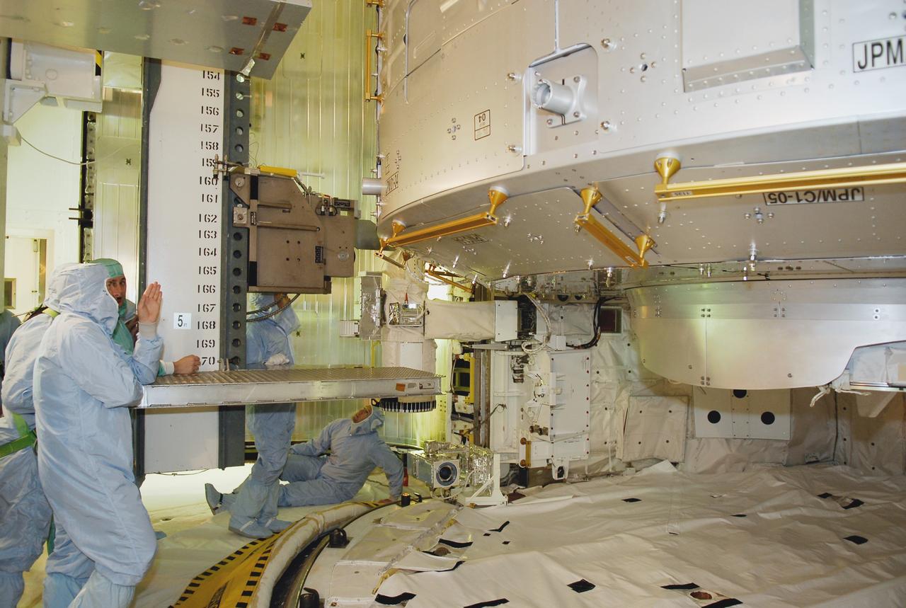 CAPE CANAVERAL, Fla. -- On Launch Pad 39A at NASA's Kennedy Space Center, STS-124 crew members get a close look at the Japanese Experiment Module – Pressurized Module and other equipment in space shuttle Discovery's payload bay. At left is Commander Mark Kelly; on the floor looking up is Pilot Ken Ham. The payload bay walkdown is part of the launch dress rehearsal called the terminal countdown demonstration test. TCDT provides astronauts and ground crews with an opportunity to participate in various simulated countdown activities, including equipment familiarization and emergency training. On the STS-124 mission, the crew will deliver and install the Japanese Experiment Module – Pressurized Module and Japanese Remote Manipulator System. Discovery's launch is targeted for May 31. Photo credit: NASA/Kim Shiflett