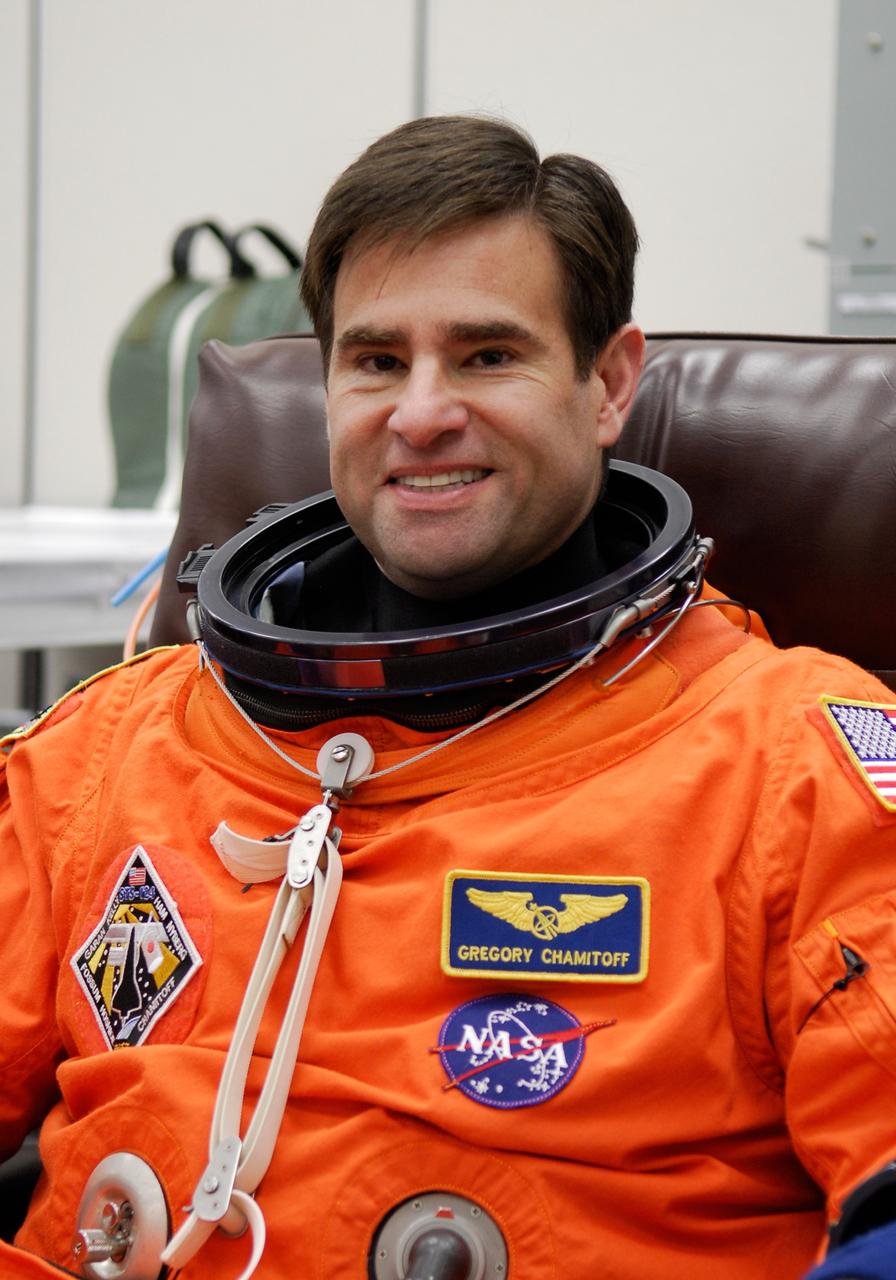 CAPE CANAVERAL, Fla. -- In the Operations and Checkout Building at NASA's Kennedy Space Center, STS-124 Mission Specialist Greg Chamitoff dons his launch-and-entry suit for the simulated launch countdown the crew is starting. The simulation is the culmination of the launch dress rehearsal called the terminal countdown demonstration test. TCDT provides astronauts and ground crews with an opportunity to participate in various simulated countdown activities, including equipment familiarization and emergency training. On the STS-124 mission, the crew will deliver and install the Japanese Experiment Module – Pressurized Module and Japanese Remote Manipulator System. Discovery's launch is targeted for May 31. Photo credit: NASA/Kim Shiflett