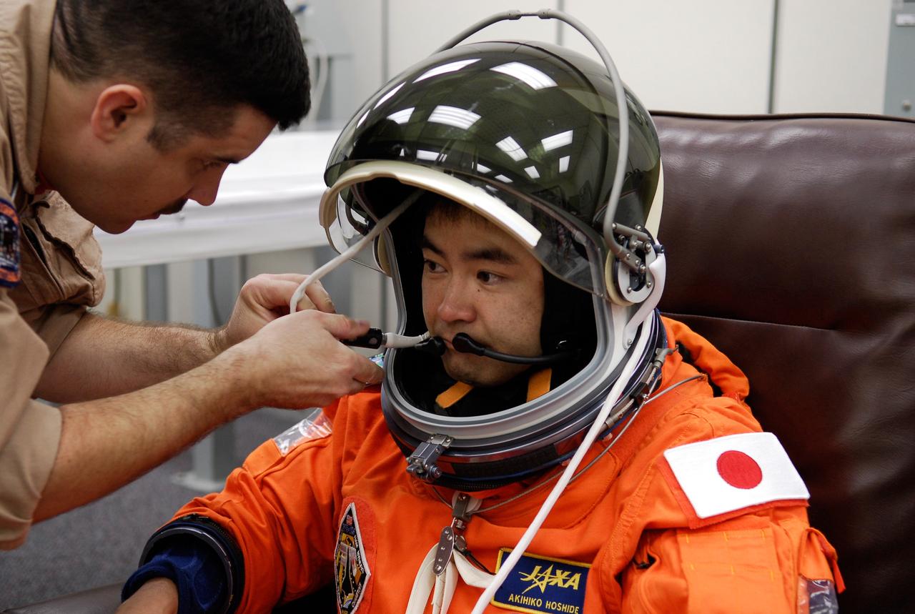 CAPE CANAVERAL, Fla. --  In the Operations and Checkout Building at NASA's Kennedy Space Center, STS-124 Mission Specialist Akihiko Hoshide has his communications adjusted in the helmet of his launch-and-entry suit.  Hoshide represents the Japan Aerospace Exploration Agency, or JAXA.  He has donned the suit for the simulated launch countdown the crew is starting. The simulation is the culmination of the launch dress rehearsal called the terminal countdown demonstration test. TCDT provides astronauts and ground crews with an opportunity to participate in various simulated countdown activities, including equipment familiarization and emergency training.  On the STS-124 mission, the crew will deliver and install the Japanese Experiment Module – Pressurized Module and Japanese Remote Manipulator System.  Discovery's launch is targeted for May 31.   Photo credit: NASA/Kim Shiflett