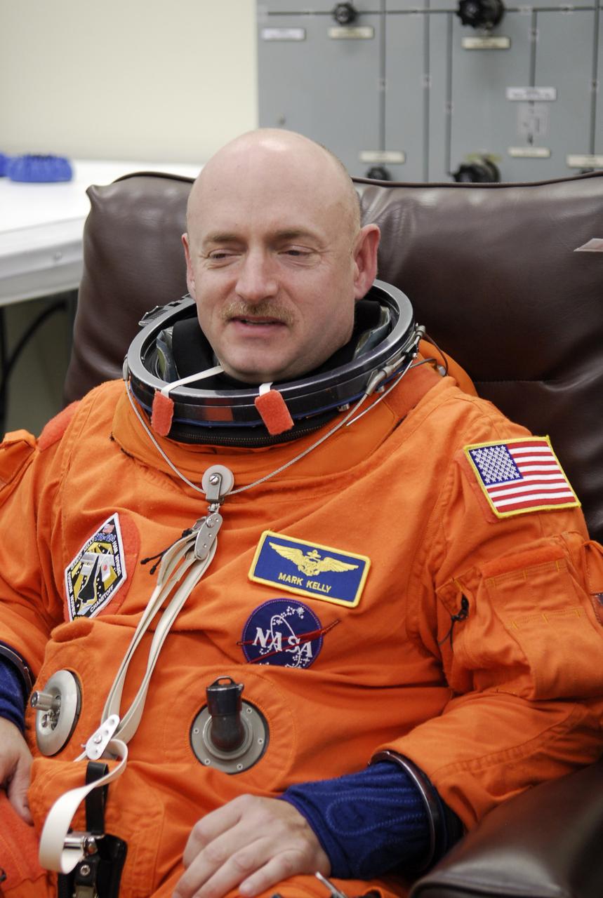 CAPE CANAVERAL, Fla. -- In the Operations and Checkout Building at NASA's Kennedy Space Center, STS-124 Commander Mark Kelly dons his launch-and-entry suit needed for the simulated launch countdown. The simulation is the culmination of the launch dress rehearsal called the terminal countdown demonstration test. TCDT provides astronauts and ground crews with an opportunity to participate in various simulated countdown activities, including equipment familiarization and emergency training. On the STS-124 mission, the crew will deliver and install the Japanese Experiment Module – Pressurized Module and Japanese Remote Manipulator System. Discovery's launch is targeted for May 31. Photo credit: NASA/Kim Shiflett