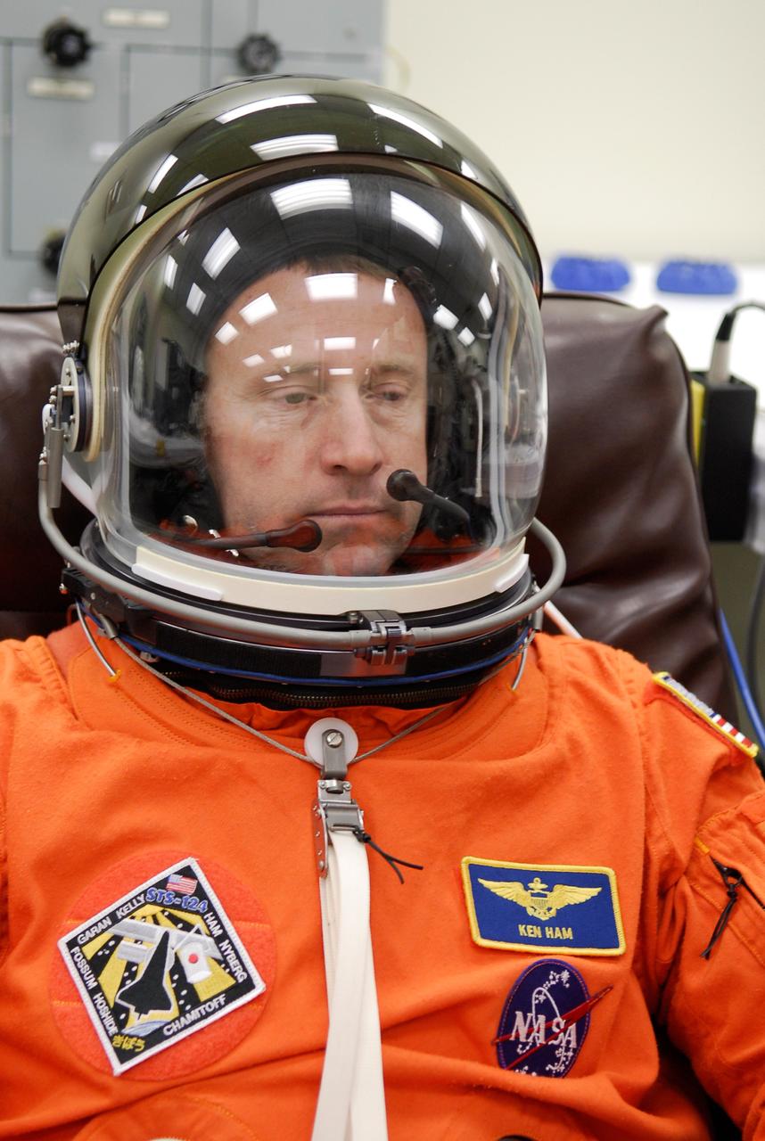 CAPE CANAVERAL, Fla. -- In the Operations and Checkout Building at NASA's Kennedy Space Center, STS-124 Pilot Ken Ham tries on his helmet. The suit fit is part of the simulated launch countdown. The simulation is the culmination of the launch dress rehearsal called the terminal countdown demonstration test. TCDT provides astronauts and ground crews with an opportunity to participate in various simulated countdown activities, including equipment familiarization and emergency training. On the STS-124 mission, the crew will deliver and install the Japanese Experiment Module – Pressurized Module and Japanese Remote Manipulator System. Discovery's launch is targeted for May 31. Photo credit: NASA/Kim Shiflett
