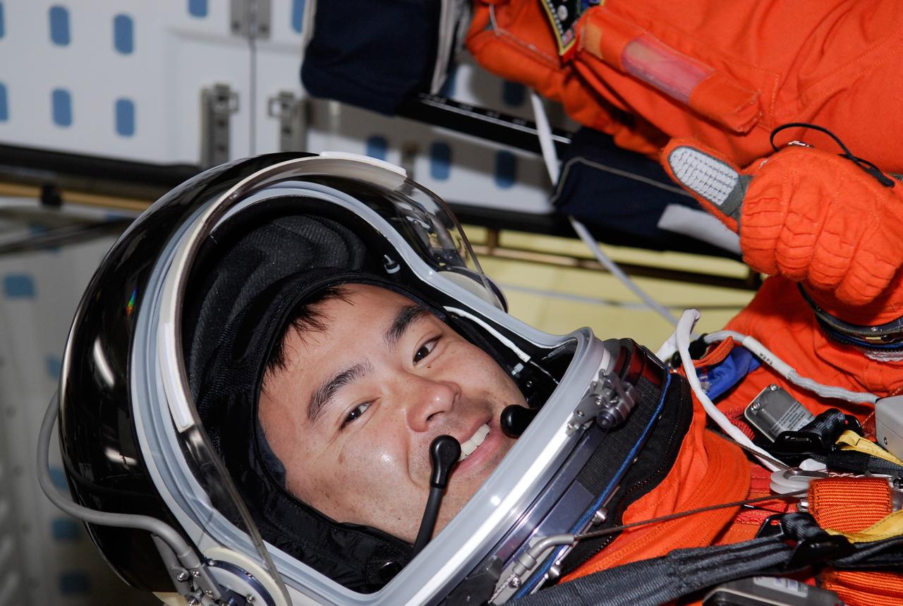CAPE CANAVERAL, Fla. -- On Launch Pad 39A at NASA's Kennedy Space Center, STS-124 Mission Specialist Akihiko Hoshide sits in his seat aboard space shuttle Discovery following the simulated launch countdown, part of the launch dress rehearsal known as the terminal countdown demonstration test. TCDT provides astronauts and ground crews with an opportunity to participate in various simulated countdown activities, including a simulated launch countdown, equipment familiarization and emergency egress training. On the STS-124 mission, the crew will deliver and install the Japanese Experiment Module – Pressurized Module and Japanese Remote Manipulator System. Discovery's launch is targeted for May 31. Photo credit: NASA/Kim Shiflett