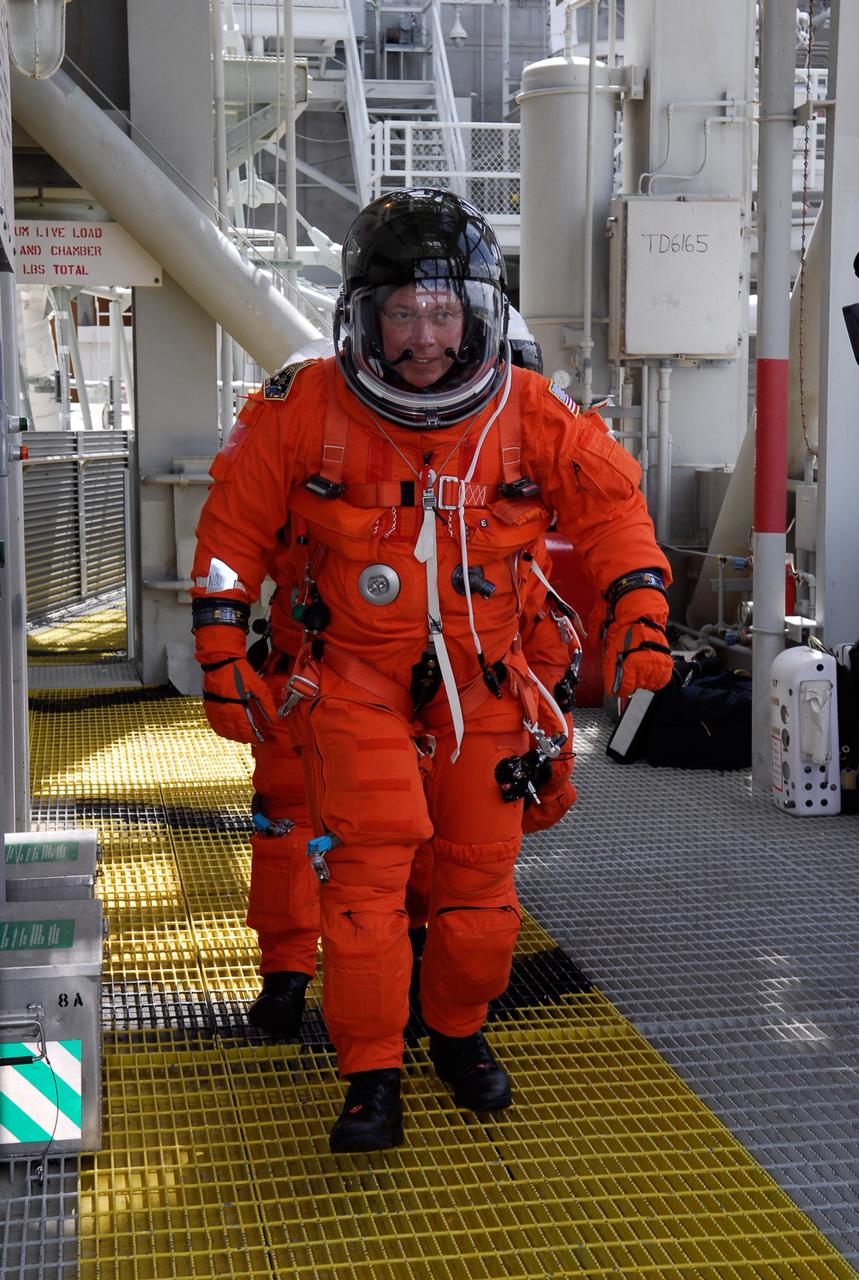 CAPE CANAVERAL, Fla. --  On Launch Pad 39A at NASA's Kennedy Space Center, STS-124 Mission Specialist Mike Fossum follows the yellow steel path to the slidewire basket area after completing the simulated launch countdown, part of the launch dress rehearsal known as the terminal countdown demonstration test. The crew is practicing emergency egress from the 195-foot level of the fixed service structure.  TCDT provides astronauts and ground crews with an opportunity to participate in various simulated countdown activities, including a simulated launch countdown, equipment familiarization and emergency egress training.  On the STS-124 mission, the crew will deliver and install the Japanese Experiment Module – Pressurized Module and Japanese Remote Manipulator System.  Discovery's launch is targeted for May 31.   Photo credit: NASA/Kim Shiflett