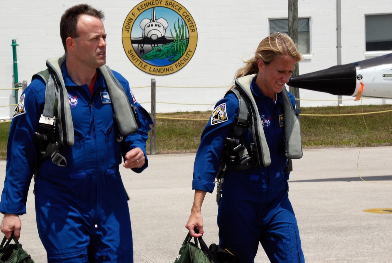 CAPE CANAVERAL, Fla. -- The crew for the STS-124 mission departs NASA's Kennedy Space Center after a successful launch dress rehearsal called the terminal countdown demonstration test. Seen here are Mission Specialists Ron Garan and Karen Nyberg heading for the T-38 training jets for their flight back to Houston. The crew is expected to return in late May for the May 31 launch of space shuttle Discovery. On the STS-124 mission, the crew will deliver and install the Japanese Experiment Module – Pressurized Module and Japanese Remote Manipulator System. Photo credit: NASA/Kim Shiflett