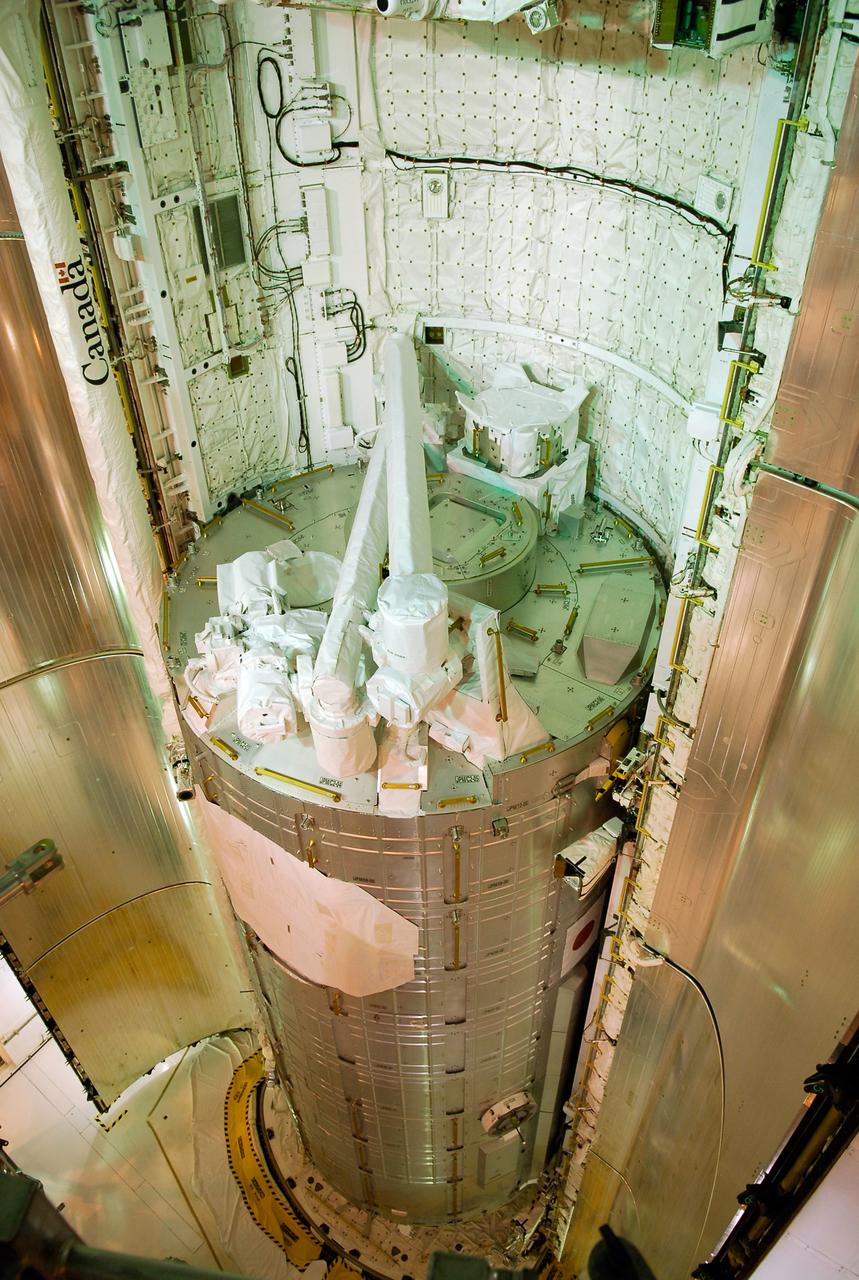 CAPE CANAVERAL, Fla. -- On Launch Pad 39A at NASA's Kennedy Space Center, the Japanese Experiment Module—Pressurized Module is in place in space shuttle Discovery's payload bay as the payload bay doors begin to close.  The launch of Discovery on its STS-124 mission is targeted for May 31.  On the mission, Discovery will transport the pressurized module and the Japanese Remote Manipulator System to the International Space Station.  Photo credit: NASA/Kim Shiflett