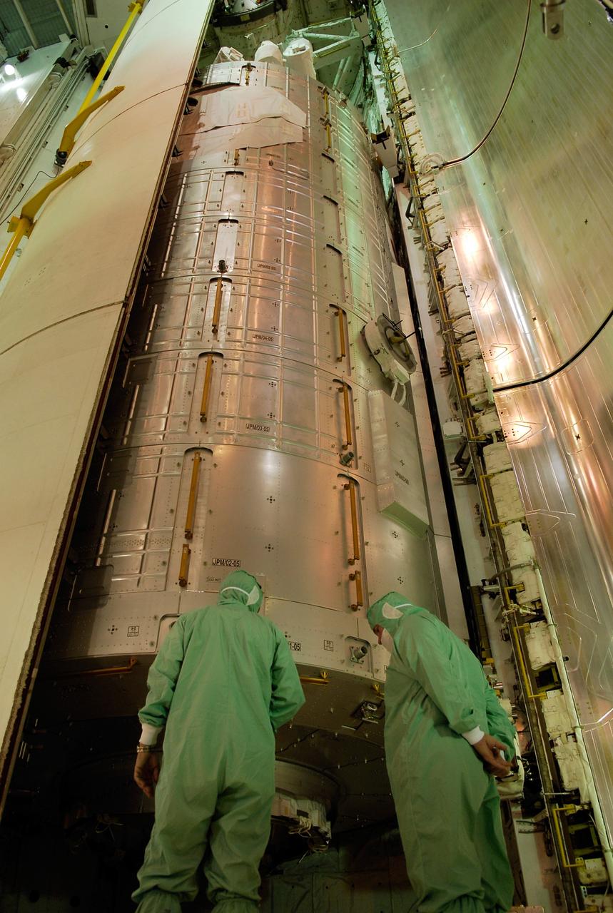CAPE CANAVERAL, Fla. -- Workers in the payload changeout room on Launch Pad 39A at NASA's Kennedy Space Center check space shuttle Discovery's  payload bay doors as they close around the Japanese Experiment Module—Pressurized Module.  The launch of Discovery on its STS-124 mission is targeted for May 31.  On the mission, Discovery will transport the pressurized module and the Japanese Remote Manipulator System to the International Space Station.  Photo credit: NASA/Kim Shiflett