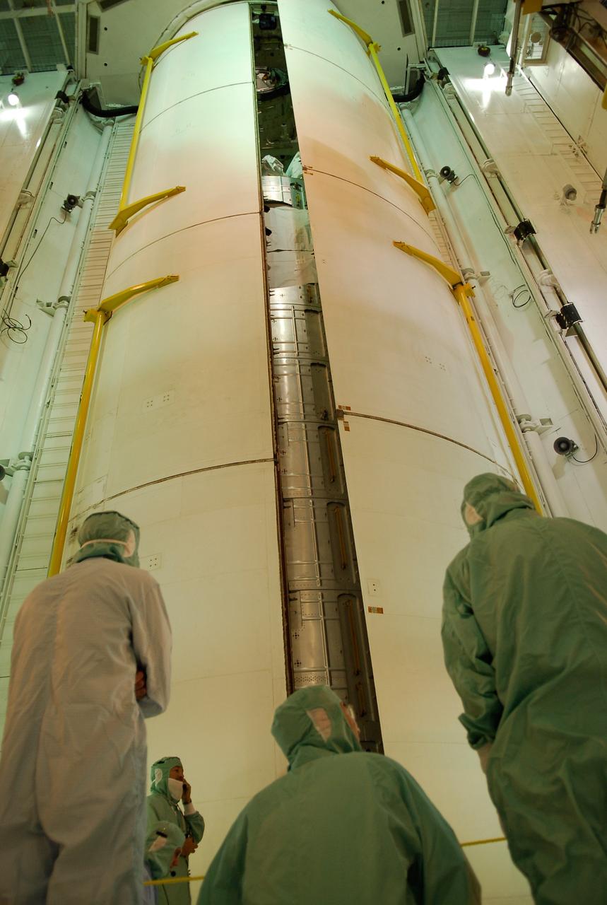CAPE CANAVERAL, Fla. -- Workers in the payload changeout room on Launch Pad 39A at NASA's Kennedy Space Center watch closely as space shuttle Discovery's  payload bay doors close around the Japanese Experiment Module—Pressurized Module.  The launch of Discovery on its STS-124 mission is targeted for May 31.  On the mission, Discovery will transport the pressurized module and the Japanese Remote Manipulator System to the International Space Station.  Photo credit: NASA/Kim Shiflett
