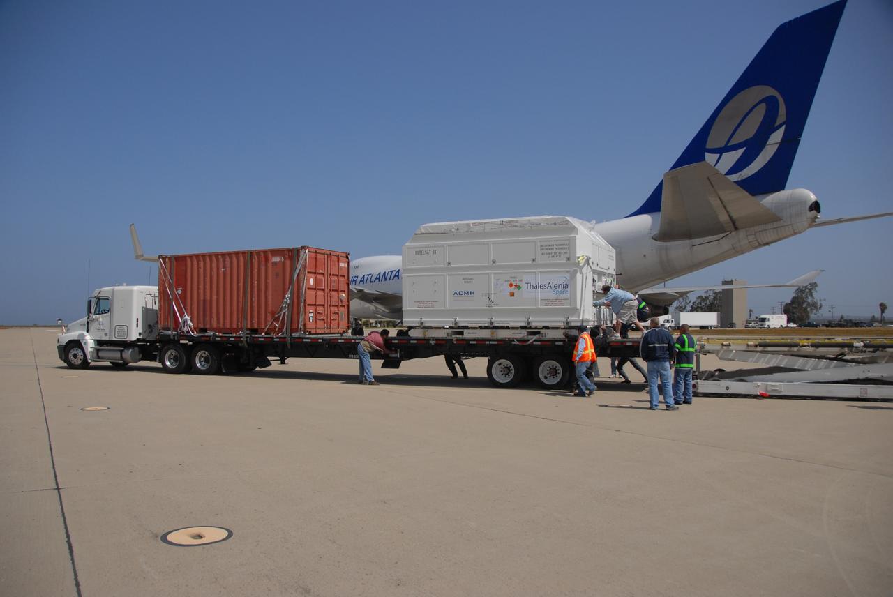 VANDENBERG AIR FORCE BASE, Calif. --   Workers move the shipping container holding the OSTM/Jason-2 satellite on a flatbed truck at Vandenberg Air Force Base.  The satellite will be transported to the Astrotech processing facility.  The OSTM, or Ocean Topography Mission, on the Jason-2 satellite is a follow-on to Jason-1. It will take oceanographic studies of sea surface height into an operational mode for continued climate forecasting research and science and industrial applications.  This satellite altimetry data will help determine ocean circulation, climate change and sea-level rise. OSTM is a joint effort by the National Oceanic and Atmospheric Administration, NASA, France’s Centre National d’Etudes Spatiales and the European Meteorological Satellite Organisation. OSTM/Jason-2 will be launched aboard a United Launch Alliance Delta II 7320 from Vandenberg on June 15.  Photo credit: NASA/Dan Liberotti