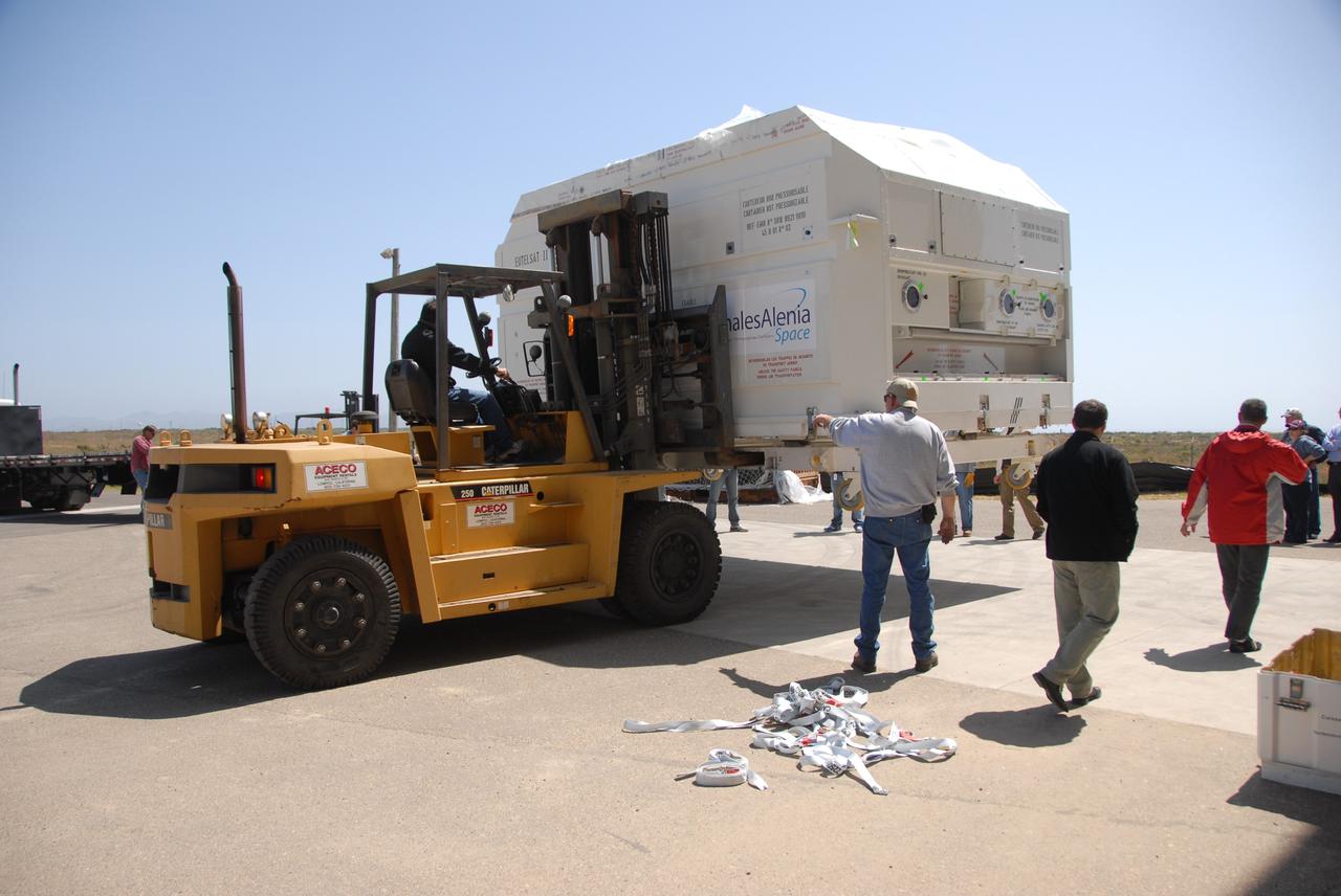 VANDENBERG AIR FORCE BASE, Calif. --  In front of the Astrotech processing facility at Vandenberg Air Force Base, a forklift has removed the OSTM/Jason-2 satellite shipping container off the flatbed truck.  The OSTM, or Ocean Topography Mission, on the Jason-2 satellite is a follow-on to Jason-1. It will take oceanographic studies of sea surface height into an operational mode for continued climate forecasting research and science and industrial applications.  This satellite altimetry data will help determine ocean circulation, climate change and sea-level rise. OSTM is a joint effort by the National Oceanic and Atmospheric Administration, NASA, France’s Centre National d’Etudes Spatiales and the European Meteorological Satellite Organisation. OSTM/Jason-2 will be launched aboard a United Launch Alliance Delta II 7320 from Vandenberg on June 15.  Photo credit: NASA/Dan Liberotti