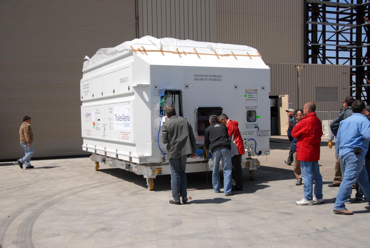 VANDENBERG AIR FORCE BASE, Calif. --  In front of the Astrotech processing facility at Vandenberg Air Force Base, the OSTM/Jason-2 satellite shipping container is on the ground, ready to be moved inside.  The OSTM, or Ocean Topography Mission, on the Jason-2 satellite is a follow-on to Jason-1. It will take oceanographic studies of sea surface height into an operational mode for continued climate forecasting research and science and industrial applications.  This satellite altimetry data will help determine ocean circulation, climate change and sea-level rise. OSTM is a joint effort by the National Oceanic and Atmospheric Administration, NASA, France’s Centre National d’Etudes Spatiales and the European Meteorological Satellite Organisation. OSTM/Jason-2 will be launched aboard a United Launch Alliance Delta II 7320 from Vandenberg on June 15.  Photo credit: NASA/Dan Liberotti