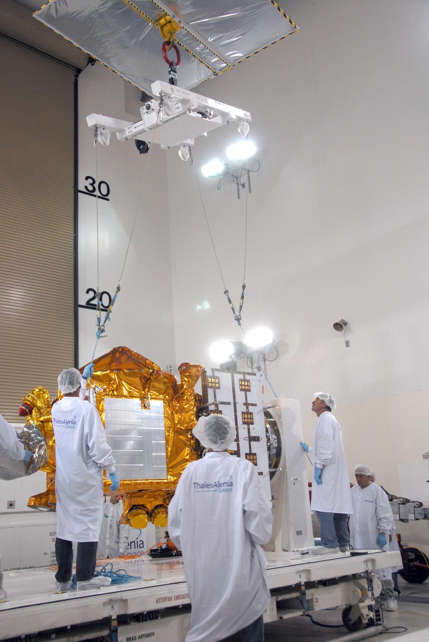 VANDENBERG AIR FORCE BASE, Calif. -- Inside the Astrotech processing facility at Vandenberg Air Force Base, an overhead crane is being attached to the OSTM/Jason-2 spacecraft.  The spacecraft will be moved to a tilt dolly.   The OSTM, or Ocean Topography Mission, on the Jason-2 satellite is a follow-on to Jason-1. It will take oceanographic studies of sea surface height into an operational mode for continued climate forecasting research and science and industrial applications.  This satellite altimetry data will help determine ocean circulation, climate change and sea-level rise. OSTM is a joint effort by the National Oceanic and Atmospheric Administration, NASA, France’s Centre National d’Etudes Spatiales and the European Meteorological Satellite Organisation. OSTM/Jason-2 will be launched aboard a United Launch Alliance Delta II 7320 from Vandenberg on June 15.  Photo credit: NASA/Mark Mackley