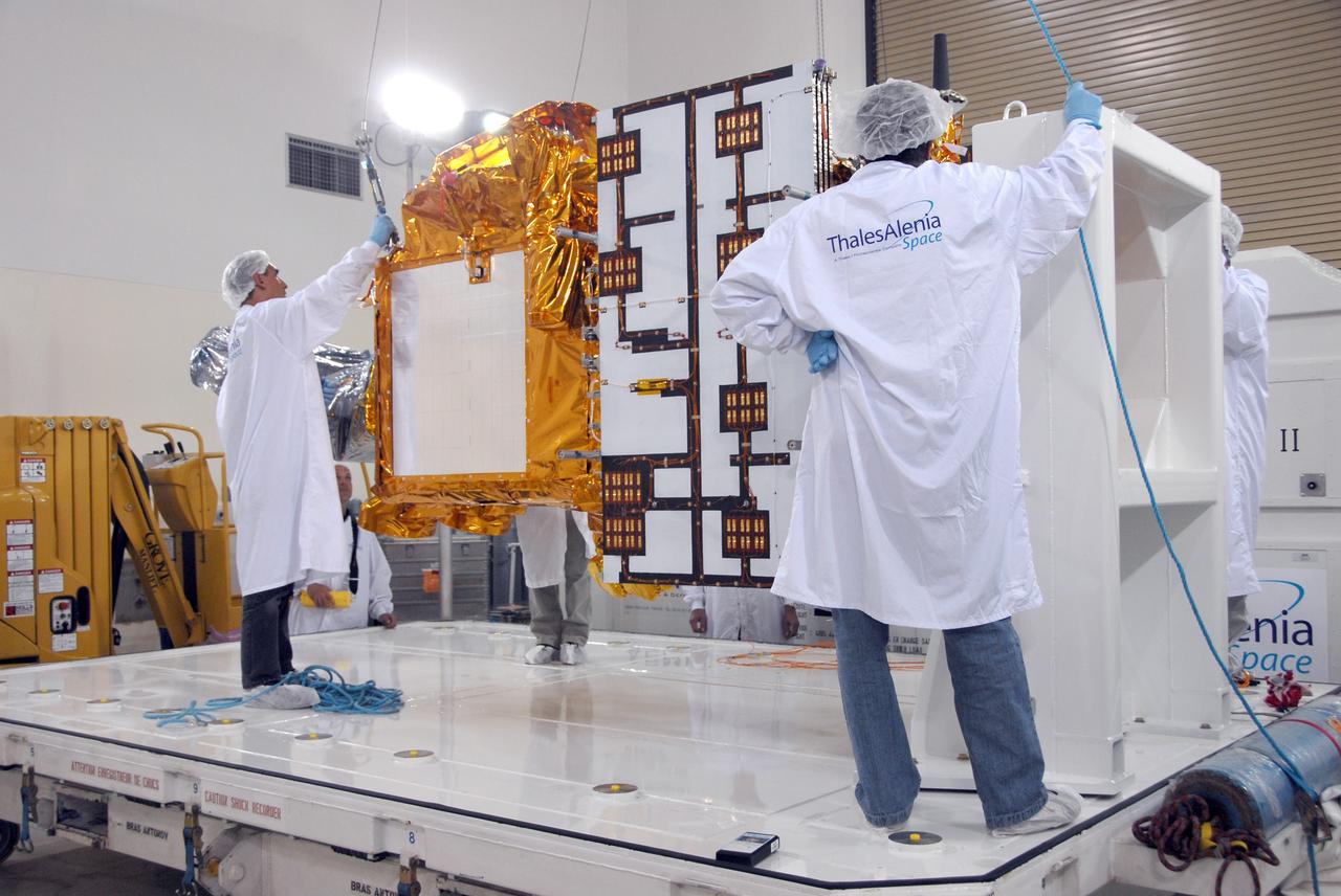 VANDENBERG AIR FORCE BASE, Calif. -- Inside the Astrotech processing facility at Vandenberg Air Force Base, workers attach an overhead crane to the OSTM/Jason-2 spacecraft.  The spacecraft will be moved to a tilt dolly.  The OSTM, or Ocean Topography Mission, on the Jason-2 satellite is a follow-on to Jason-1. It will take oceanographic studies of sea surface height into an operational mode for continued climate forecasting research and science and industrial applications.  This satellite altimetry data will help determine ocean circulation, climate change and sea-level rise. OSTM is a joint effort by the National Oceanic and Atmospheric Administration, NASA, France’s Centre National d’Etudes Spatiales and the European Meteorological Satellite Organisation. OSTM/Jason-2 will be launched aboard a United Launch Alliance Delta II 7320 from Vandenberg on June 15.  Photo credit: NASA/Mark Mackley