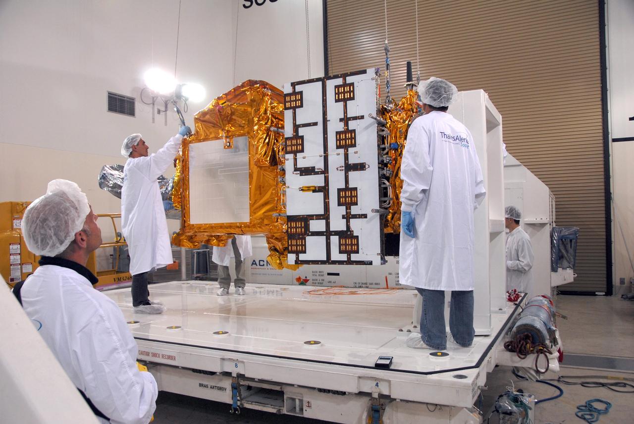 VANDENBERG AIR FORCE BASE, Calif. -- Inside the Astrotech processing facility at Vandenberg Air Force Base, technicians attach an overhead crane to the OSTM/Jason-2 spacecraft.  The spacecraft will be moved to a tilt dolly.  The OSTM, or Ocean Topography Mission, on the Jason-2 satellite is a follow-on to Jason-1. It will take oceanographic studies of sea surface height into an operational mode for continued climate forecasting research and science and industrial applications.  This satellite altimetry data will help determine ocean circulation, climate change and sea-level rise. OSTM is a joint effort by the National Oceanic and Atmospheric Administration, NASA, France’s Centre National d’Etudes Spatiales and the European Meteorological Satellite Organisation. OSTM/Jason-2 will be launched aboard a United Launch Alliance Delta II 7320 from Vandenberg on June 15.  Photo credit: NASA/Mark Mackley