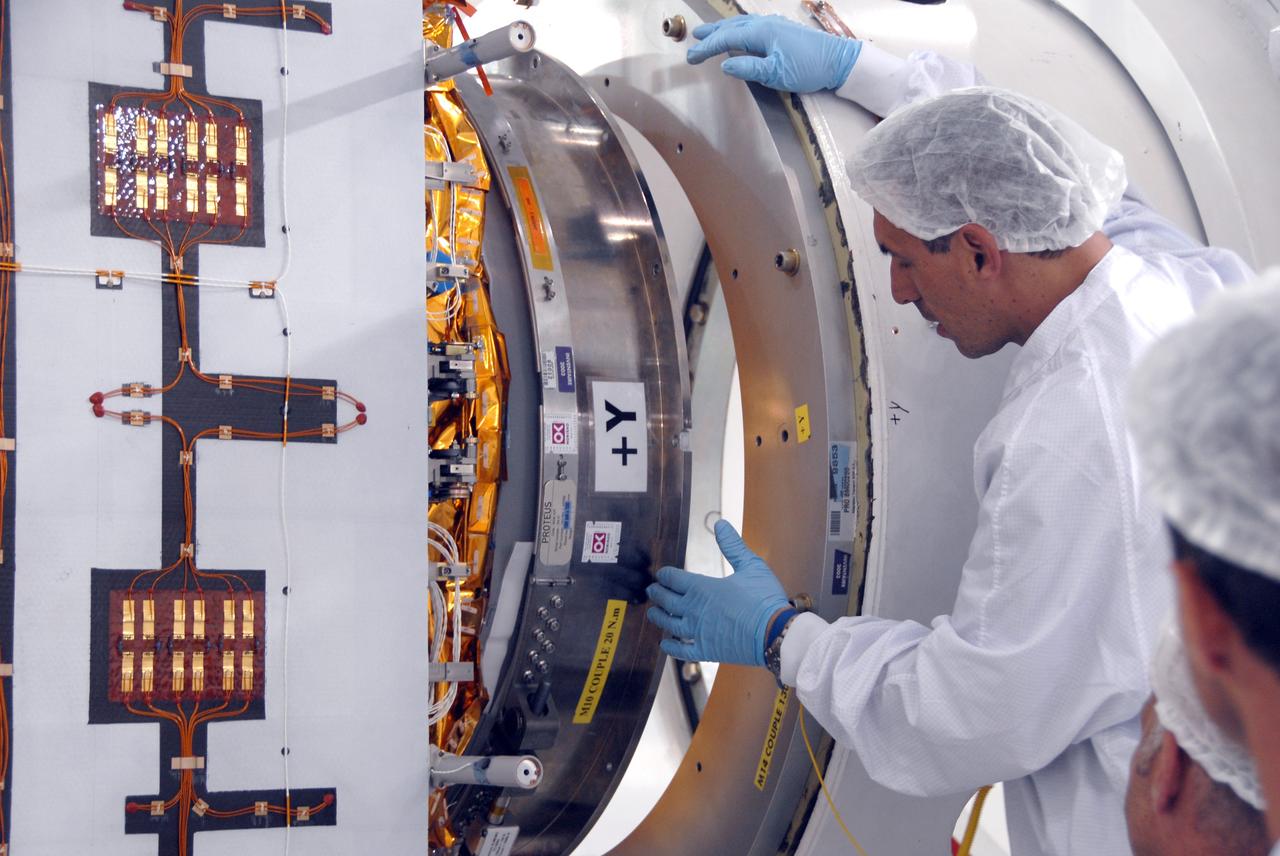 VANDENBERG AIR FORCE BASE, Calif. --  Inside the Astrotech processing facility at Vandenberg Air Force Base, a technician oversees the attaching of the OSTM/Jason-2 spacecraft to a tilt dolly.  The OSTM, or Ocean Topography Mission, on the Jason-2 satellite is a follow-on to Jason-1. It will take oceanographic studies of sea surface height into an operational mode for continued climate forecasting research and science and industrial applications.  This satellite altimetry data will help determine ocean circulation, climate change and sea-level rise. OSTM is a joint effort by the National Oceanic and Atmospheric Administration, NASA, France’s Centre National d’Etudes Spatiales and the European Meteorological Satellite Organisation. OSTM/Jason-2 will be launched aboard a United Launch Alliance Delta II 7320 from Vandenberg on June 15.  Photo credit: NASA/Mark Mackley