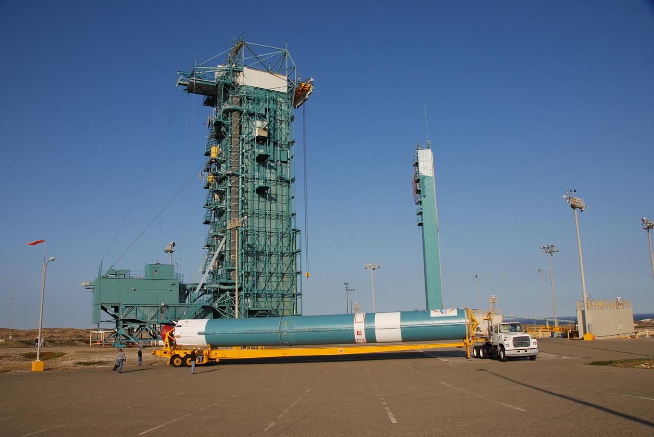 VANDENBERG AIR FORCE BASE, Calif. --  At Vandenberg Air Force Base in California, the Delta II first stage for the OSTM/Jason-2 spacecraft arrives on Space Launch Complex 2.  The first stage will be raised to vertical and lifted into the mobile service tower (behind it, at left).  The OSTM, or Ocean Topography Mission, on the Jason-2 satellite is a follow-on to Jason-1. It will take oceanographic studies of sea surface height into an operational mode for continued climate forecasting research and science and industrial applications.  This satellite altimetry data will help determine ocean circulation, climate change and sea-level rise. OSTM is a joint effort by the National Oceanic and Atmospheric Administration, NASA, France’s Centre National d’Etudes Spatiales and the European Meteorological Satellite Organisation. OSTM/Jason-2 will be launched aboard a United Launch Alliance Delta II 7320 from Vandenberg on June 15.  Photo credit: NASA/Dan Liberotti