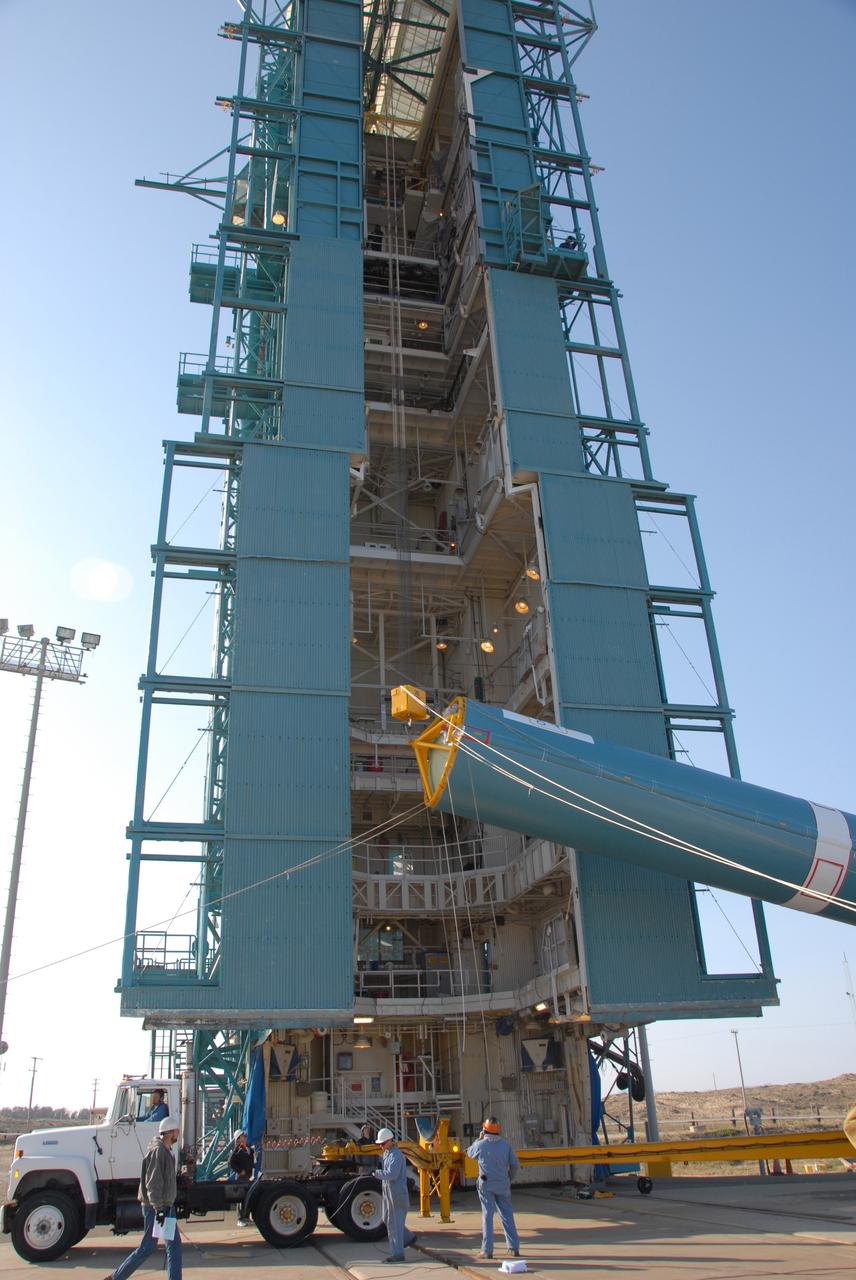 VANDENBERG AIR FORCE BASE, Calif. --  At Vandenberg Air Force Base in California, the Delta II first stage is being raised to a vertical position in front of the mobile service tower on Space Launch Complex 2.  Once it is vertical, the first stage will be transferred into the tower. The Delta II is the launch vehicle for the OSTM/Jason-2 spacecraft.  The OSTM, or Ocean Topography Mission, on the Jason-2 satellite is a follow-on to Jason-1. It will take oceanographic studies of sea surface height into an operational mode for continued climate forecasting research and science and industrial applications.  This satellite altimetry data will help determine ocean circulation, climate change and sea-level rise. OSTM is a joint effort by the National Oceanic and Atmospheric Administration, NASA, France’s Centre National d’Etudes Spatiales and the European Meteorological Satellite Organisation. OSTM/Jason-2 will be launched aboard a United Launch Alliance Delta II 7320 from Vandenberg on June 15.  Photo credit: NASA/Dan Liberotti