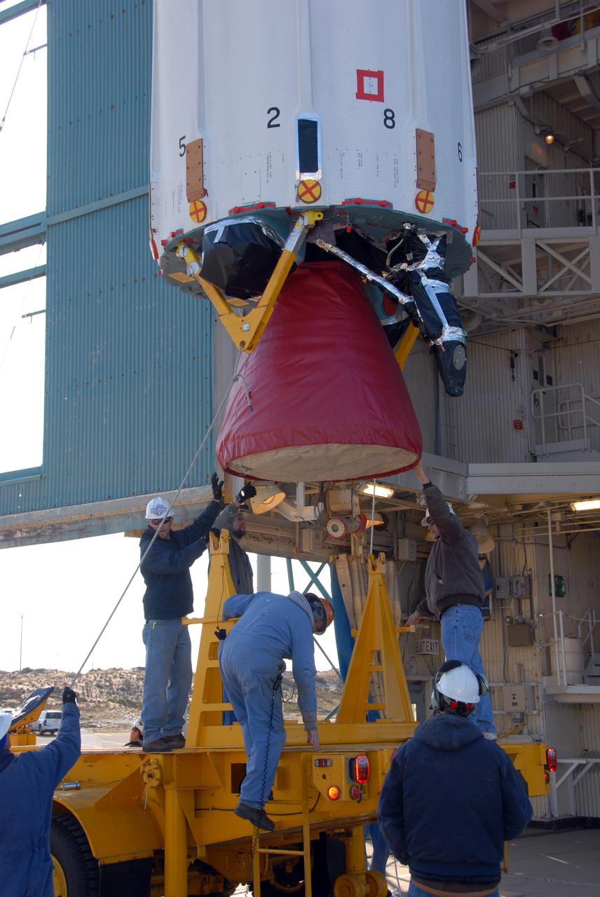 VANDENBERG AIR FORCE BASE, Calif. --  At Vandenberg Air Force Base in California, workers prepare to move the transporter from beneath the Delta II first stage, suspended above, on Space Launch Complex 2.  The first stage will be lifted into the mobile service tower. The Delta II is the launch vehicle for the OSTM/Jason-2 spacecraft.  The OSTM, or Ocean Topography Mission, on the Jason-2 satellite is a follow-on to Jason-1. It will take oceanographic studies of sea surface height into an operational mode for continued climate forecasting research and science and industrial applications.  This satellite altimetry data will help determine ocean circulation, climate change and sea-level rise. OSTM is a joint effort by the National Oceanic and Atmospheric Administration, NASA, France’s Centre National d’Etudes Spatiales and the European Meteorological Satellite Organisation. OSTM/Jason-2 will be launched aboard a United Launch Alliance Delta II 7320 from Vandenberg on June 15.  Photo credit: NASA/Dan Liberotti