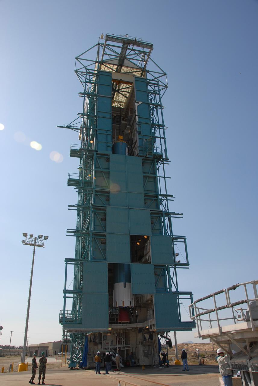 VANDENBERG AIR FORCE BASE, Calif. --  At Vandenberg Air Force Base in California, protective panels on the mobile service tower on Space Launch Complex 2 are moved to cover the Delta II first stage, which is the launch vehicle for the OSTM/Jason-2 spacecraft. The Delta II is being moved to the umbilical tower/launcher at right.  The OSTM, or Ocean Topography Mission, on the Jason-2 satellite is a follow-on to Jason-1. It will take oceanographic studies of sea surface height into an operational mode for continued climate forecasting research and science and industrial applications.  This satellite altimetry data will help determine ocean circulation, climate change and sea-level rise. OSTM is a joint effort by the National Oceanic and Atmospheric Administration, NASA, France’s Centre National d’Etudes Spatiales and the European Meteorological Satellite Organisation. OSTM/Jason-2 will be launched aboard a United Launch Alliance Delta II 7320 from Vandenberg on June 15.  Photo credit: NASA/Dan Liberotti