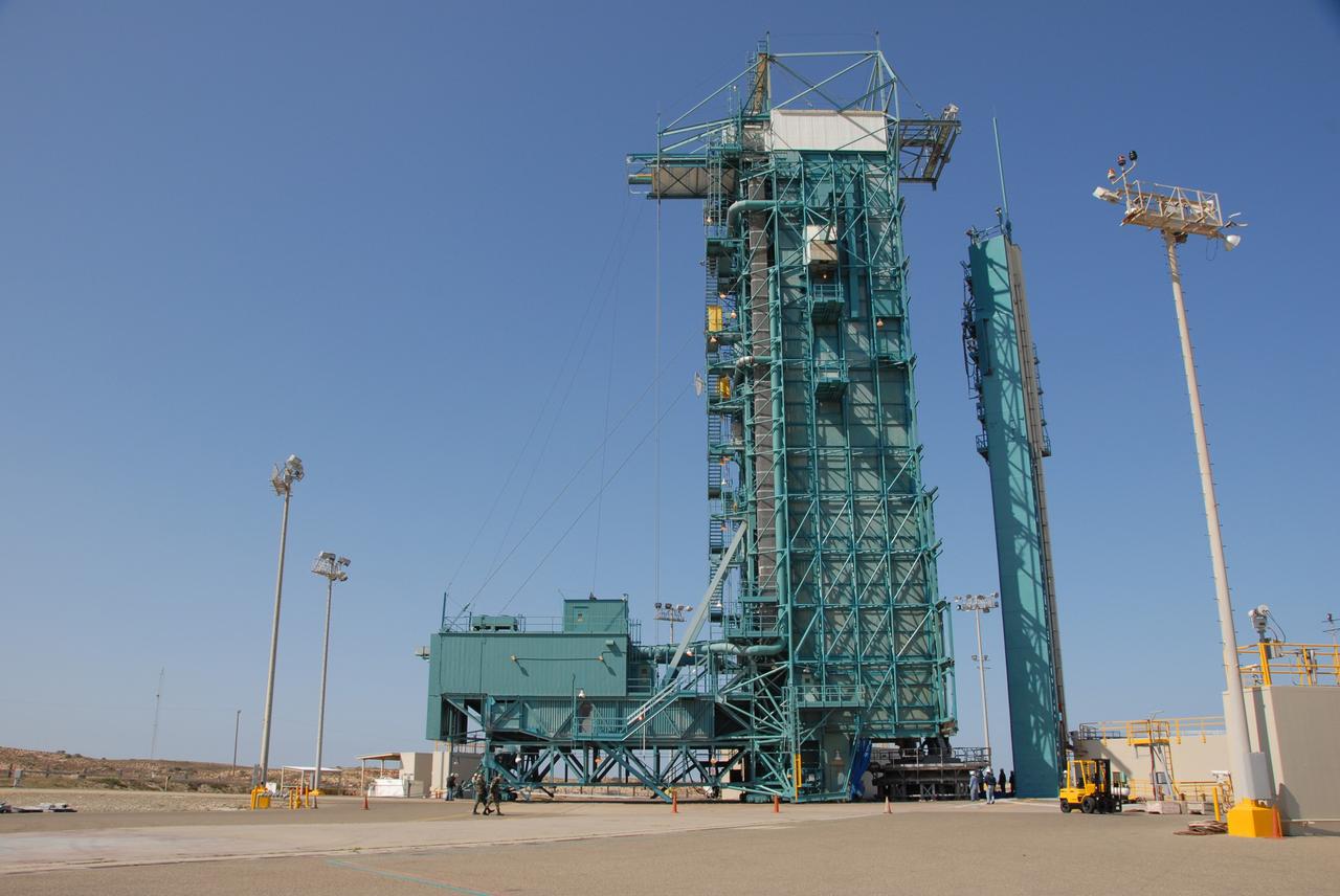 VANDENBERG AIR FORCE BASE, Calif. -- On Space Launch Complex 2 at Vandenberg Air Force Base in California, the mobile service tower with the Delta II first stage moves closer to the umbilical tower/launcher at right.  The Delta II is the launch vehicle for the OSTM/Jason-2 spacecraft. The OSTM, or Ocean Topography Mission, on the Jason-2 satellite is a follow-on to Jason-1. It will take oceanographic studies of sea surface height into an operational mode for continued climate forecasting research and science and industrial applications.  This satellite altimetry data will help determine ocean circulation, climate change and sea-level rise. OSTM is a joint effort by the National Oceanic and Atmospheric Administration, NASA, France’s Centre National d’Etudes Spatiales and the European Meteorological Satellite Organisation. OSTM/Jason-2 will be launched aboard a United Launch Alliance Delta II 7320 from Vandenberg on June 15.  Photo credit: NASA/Dan Liberotti