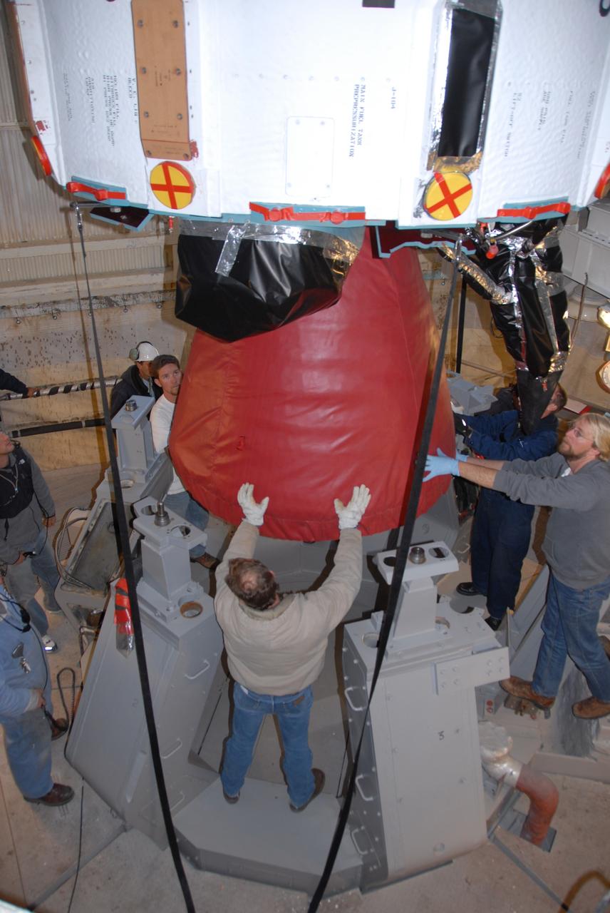 VANDENBERG AIR FORCE BASE, Calif. -- On Space Launch Complex 2 at Vandenberg Air Force Base in California, workers center the Delta II first stage for the OSTM/Jason-2 spacecraft above the launcher in the umbilical tower. The OSTM, or Ocean Topography Mission, on the Jason-2 satellite is a follow-on to Jason-1. It will take oceanographic studies of sea surface height into an operational mode for continued climate forecasting research and science and industrial applications.  This satellite altimetry data will help determine ocean circulation, climate change and sea-level rise. OSTM is a joint effort by the National Oceanic and Atmospheric Administration, NASA, France’s Centre National d’Etudes Spatiales and the European Meteorological Satellite Organisation. OSTM/Jason-2 will be launched aboard a United Launch Alliance Delta II 7320 from Vandenberg on June 15.  Photo credit: NASA/Dan Liberotti