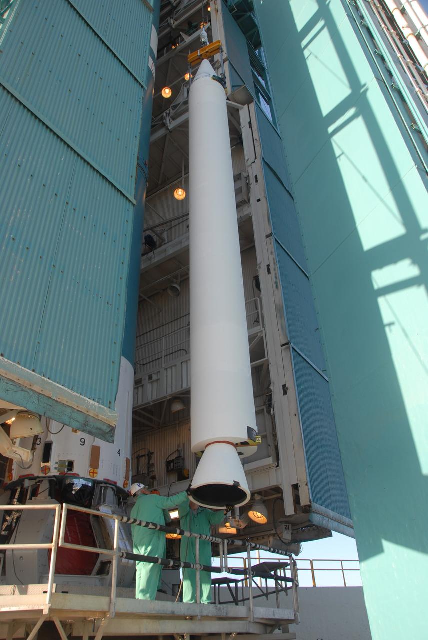 VANDENBERG AIR FORCE BASE, Calif. -- On Space Launch Complex 2 at Vandenberg Air Force Base in California, a solid rocket motor, or SRM, is lifted alongside the mobile service tower.  The SRM will be moved inside the tower and attached to the Delta II first stage, which is the launch vehicle for the OSTM/Jason-2 spacecraft.  The OSTM, or Ocean Topography Mission, on the Jason-2 satellite is a follow-on to Jason-1. It will take oceanographic studies of sea surface height into an operational mode for continued climate forecasting research and science and industrial applications.  This satellite altimetry data will help determine ocean circulation, climate change and sea-level rise. OSTM is a joint effort by the National Oceanic and Atmospheric Administration, NASA, France’s Centre National d’Etudes Spatiales and the European Meteorological Satellite Organisation. OSTM/Jason-2 will be launched aboard a United Launch Alliance Delta II 7320 from Vandenberg on June 15.  Photo credit: NASA/Dan Liberotti