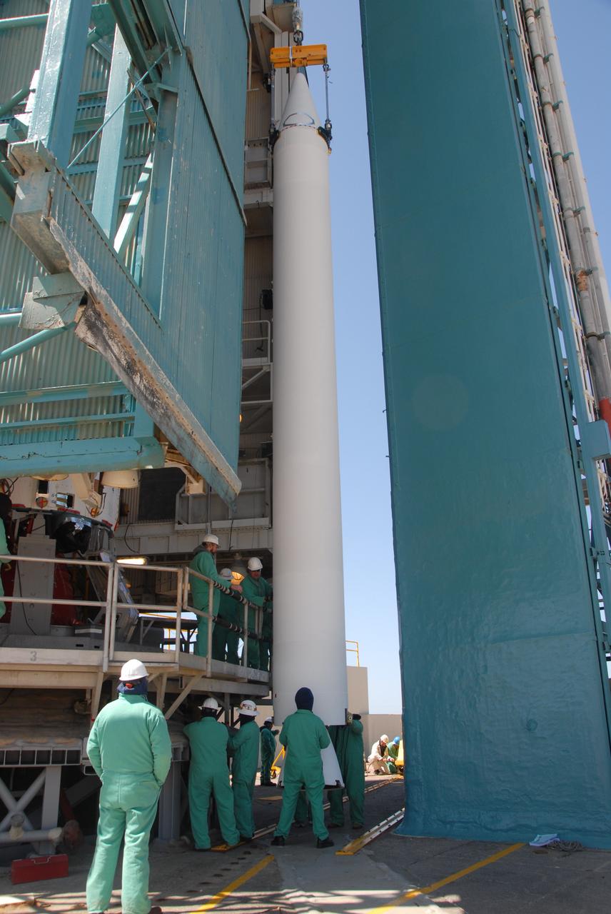 VANDENBERG AIR FORCE BASE, Calif. --   On Space Launch Complex 2 at Vandenberg Air Force Base in California, the second solid rocket motor, or SRM, is suspended in front of the mobile service tower.  The SRM will be lifted into the tower and attached to the Delta II first stage inside.  The Delta II is the launch vehicle for the OSTM/Jason-2 spacecraft.  The OSTM, or Ocean Topography Mission, on the Jason-2 satellite is a follow-on to Jason-1. It will take oceanographic studies of sea surface height into an operational mode for continued climate forecasting research and science and industrial applications.  This satellite altimetry data will help determine ocean circulation, climate change and sea-level rise. OSTM is a joint effort by the National Oceanic and Atmospheric Administration, NASA, France’s Centre National d’Etudes Spatiales and the European Meteorological Satellite Organisation. OSTM/Jason-2 will be launched aboard a United Launch Alliance Delta II 7320 from Vandenberg on June 15.  Photo credit: NASA/Dan Liberotti