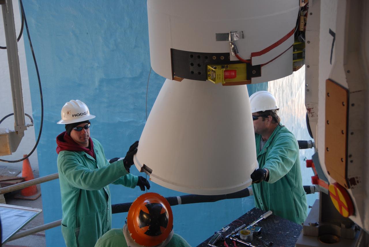 VANDENBERG AIR FORCE BASE, Calif. --  On Space Launch Complex 2 at Vandenberg Air Force Base in California, workers aid the movement of the solid rocket motor, or SRM, into the mobile service tower.  The SRM will be attached to the Delta II first stage inside the tower.  The Delta II is the launch vehicle for the OSTM/Jason-2 spacecraft.  The OSTM, or Ocean Topography Mission, on the Jason-2 satellite is a follow-on to Jason-1. It will take oceanographic studies of sea surface height into an operational mode for continued climate forecasting research and science and industrial applications.  This satellite altimetry data will help determine ocean circulation, climate change and sea-level rise. OSTM is a joint effort by the National Oceanic and Atmospheric Administration, NASA, France’s Centre National d’Etudes Spatiales and the European Meteorological Satellite Organisation. OSTM/Jason-2 will be launched aboard a United Launch Alliance Delta II 7320 from Vandenberg on June 15.  Photo credit: NASA/Dan Liberotti