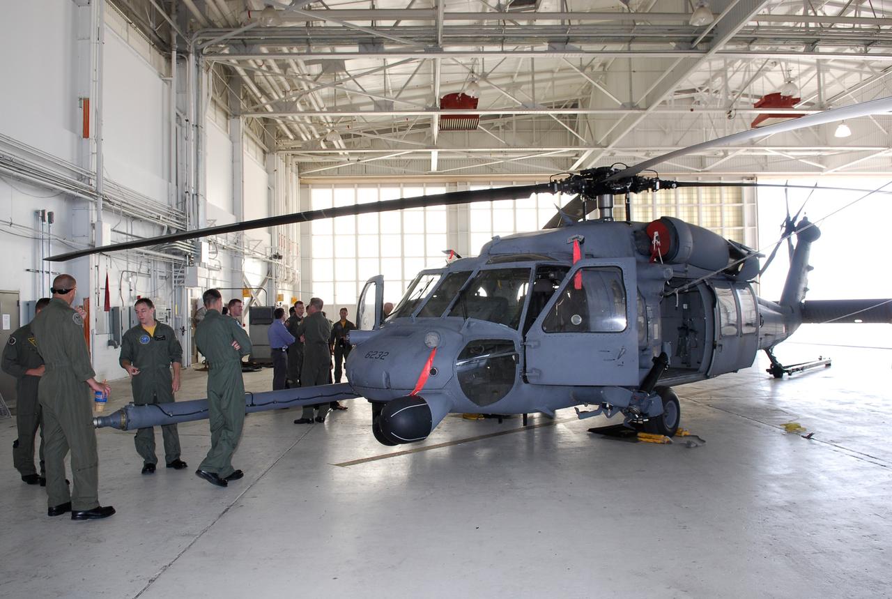 CAPE CANAVERAL, Fla. -- Participants in the Mode VIII exercise being conducted at Patrick Air Force Base, Fla., are introduced to the equipment they will be working with.  In the foreground is an HH-60 helicopter.  In support of, and with logistical support from, NASA, USSTRATCOM is hosting a major exercise involving Department of Defense, Department of Homeland Security, search and rescue (SAR) forces, including the 45th Space Wing at Patrick Air Force Base, which support space shuttle astronaut bailout contingency operations, known as Mode VIII.  This exercise tests SAR capabilities to locate, recover and provide medical treatment for astronauts following a space shuttle launch phase open-ocean bailout. Participants include members of the U.S. Navy, U.S. Coast Guard, U.S. Air Force, and NASA's Kennedy Space Center and Johnson Space Center.  This will be the 15th Mode VIII exercise conducted in the past 20 years.  Photo credit: NASA/Kim Shiflett