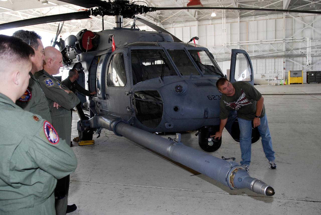 CAPE CANAVERAL, Fla. -- A representative of the 301st Rescue Squadron familiarizes participants in the Mode VIII exercise with the HH-60G helicopter that will play a part. The Mode VIII is being conducted at Patrick Air Force Base, Fla. In support of, and with logistical support from, NASA, USSTRATCOM is hosting a major exercise involving Department of Defense, Department of Homeland Security, search and rescue (SAR) forces, including the 45th Space Wing at Patrick Air Force Base, which support space shuttle astronaut bailout contingency operations, known as Mode VIII. This exercise tests SAR capabilities to locate, recover and provide medical treatment for astronauts following a space shuttle launch phase open-ocean bailout. Participants include members of the U.S. Navy, U.S. Coast Guard, U.S. Air Force, and NASA's Kennedy Space Center and Johnson Space Center. This will be the 15th Mode VIII exercise conducted in the past 20 years. Photo credit: NASA/Kim Shiflett