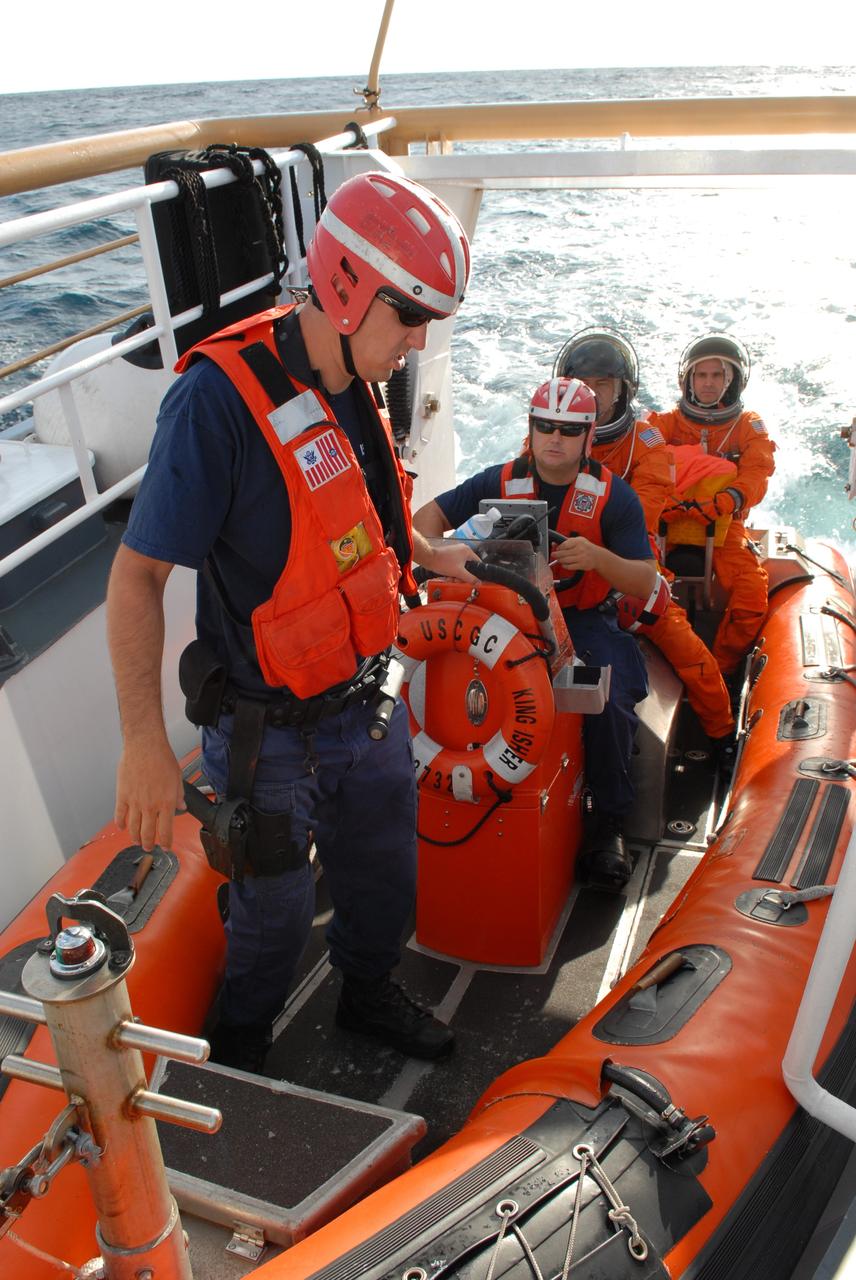 CAPE CANAVERAL, Fla. -- In a U.S. Coast Guard rescue boat off Florida's central east coast, participants in a rescue training exercise, known as Mode VIII, are ready to be launched into the Atlantic Ocean.  In support of, and with logistical support from, NASA, USSTRATCOM is hosting a major exercise involving Department of Defense, Department of Homeland Security, search and rescue (SAR) forces, including the 45th Space Wing at Patrick Air Force Base, which support space shuttle astronaut bailout contingency operations, known as Mode VIII.  This exercise tests SAR capabilities to locate, recover and provide medical treatment for astronauts following a space shuttle launch phase open-ocean bailout. Participants include members of the U.S. Navy, U.S. Coast Guard, U.S. Air Force, and NASA's Kennedy Space Center and Johnson Space Center.  Photo credit: NASA/Dimitri Gerondidakis