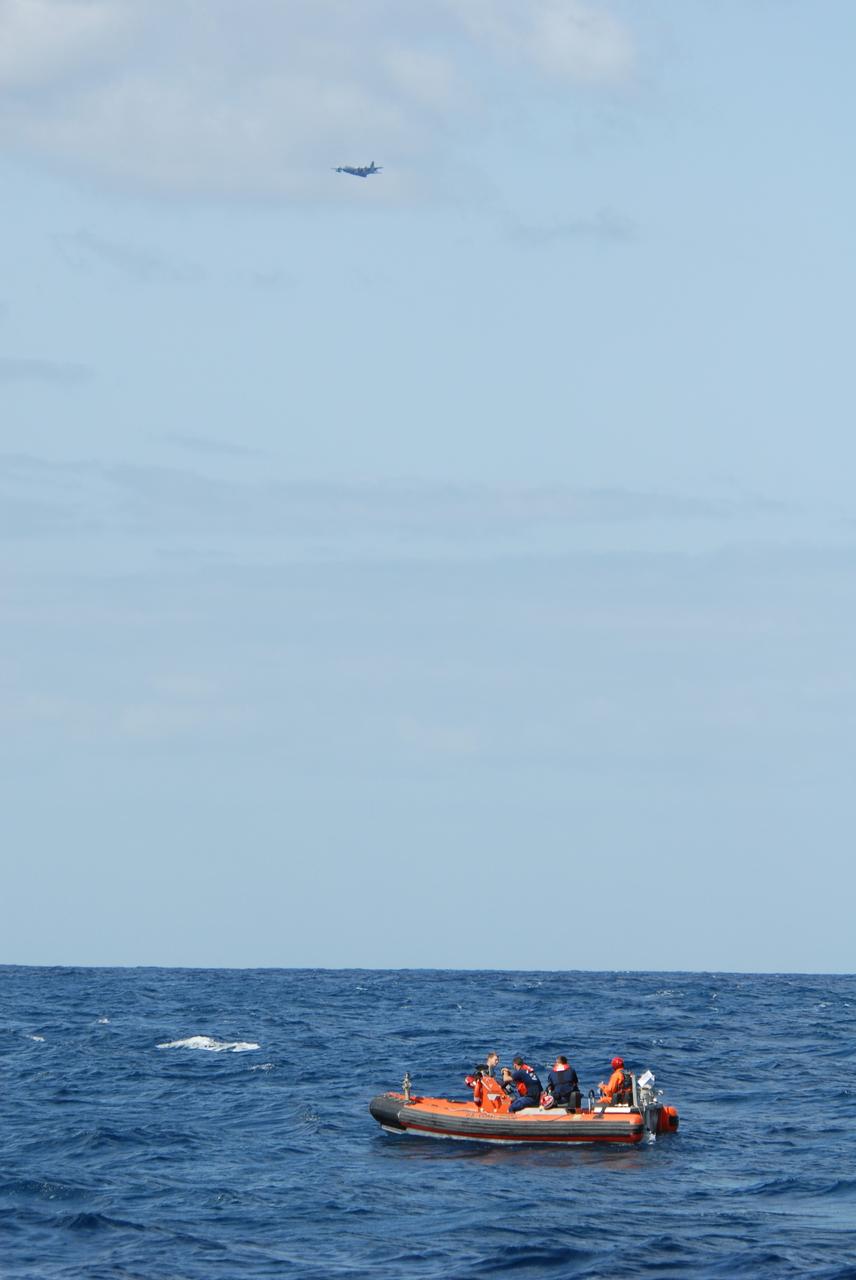 CAPE CANAVERAL, Fla. -- Participants take part in a rescue training exercise, known as Mode VIII, off Florida's central east coast while a U.S. Coast Guard HU-25 Falcon jet flies overhead. In support of, and with logistical support from, NASA, USSTRATCOM is hosting a major exercise involving Department of Defense, Department of Homeland Security, search and rescue (SAR) forces, including the 45th Space Wing at Patrick Air Force Base, which support space shuttle astronaut bailout contingency operations, known as Mode VIII. This exercise tests SAR capabilities to locate, recover and provide medical treatment for astronauts following a space shuttle launch phase open-ocean bailout. Participants include members of the U.S. Navy, U.S. Coast Guard, U.S. Air Force, and NASA's Kennedy Space Center and Johnson Space Center. Photo credit: NASA/Dimitri Gerondidakis