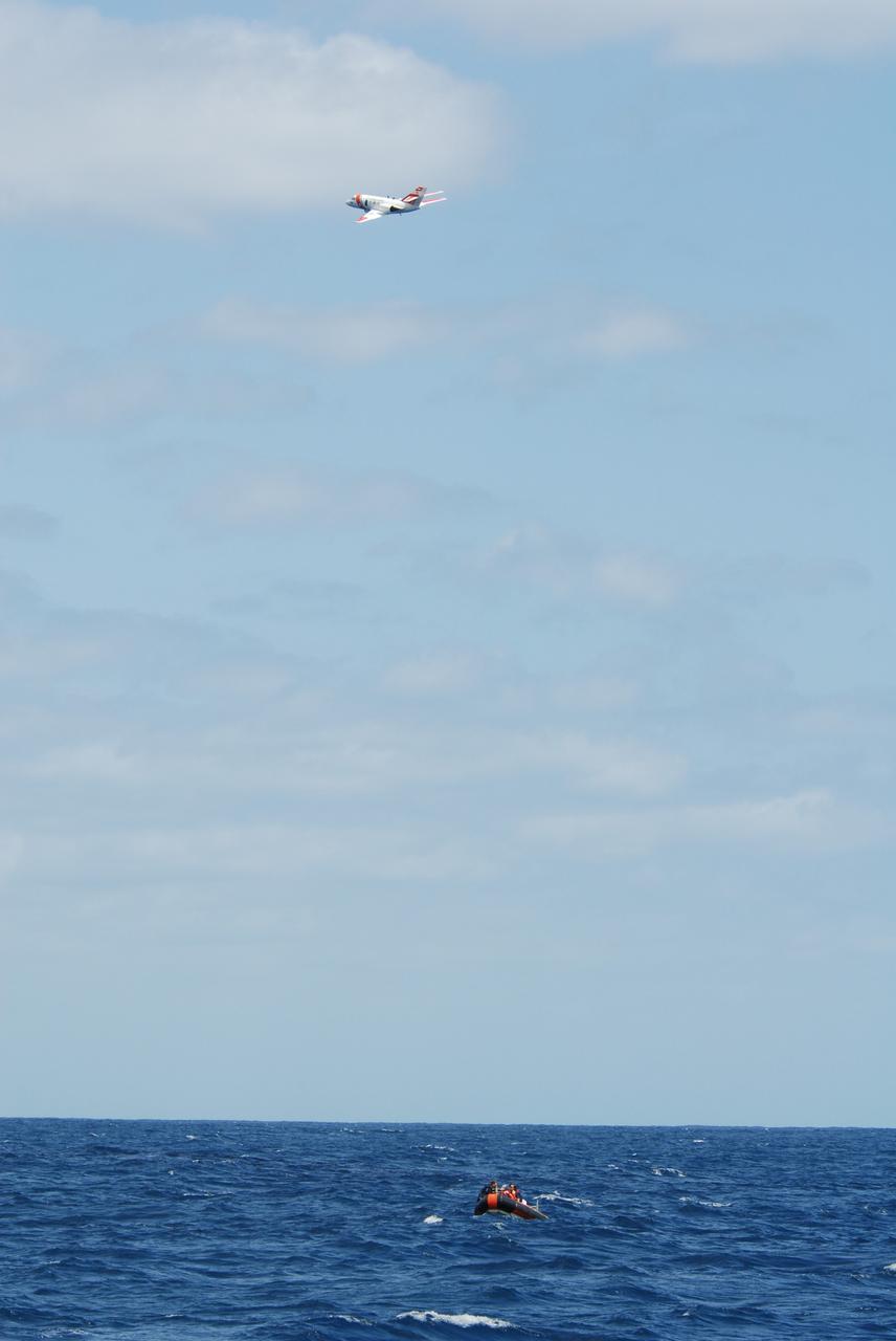 CAPE CANAVERAL, Fla. -- A U.S. Coast Guard HU-25 Falcon jet flies over a rescue boat during a training exercise, known as Mode VIII, off Florida's central east coast. In support of, and with logistical support from, NASA, USSTRATCOM is hosting a major exercise involving Department of Defense, Department of Homeland Security, search and rescue (SAR) forces, including the 45th Space Wing at Patrick Air Force Base, which support space shuttle astronaut bailout contingency operations, known as Mode VIII. This exercise tests SAR capabilities to locate, recover and provide medical treatment for astronauts following a space shuttle launch phase open-ocean bailout. Participants include members of the U.S. Navy, U.S. Coast Guard, U.S. Air Force, and NASA's Kennedy Space Center and Johnson Space Center. Photo credit: NASA/Dimitri Gerondidakis