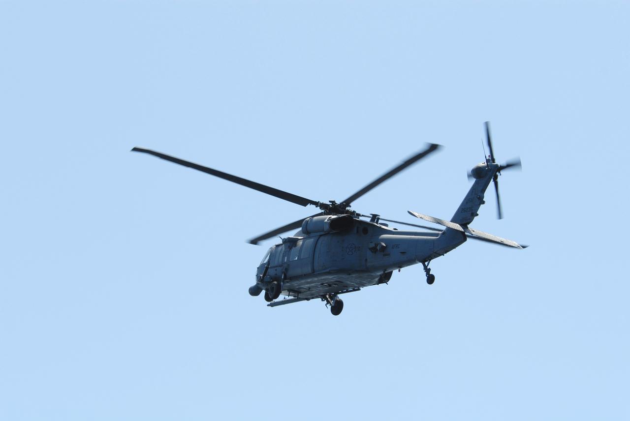 CAPE CANAVERAL, Fla. -- An HH-60G helicopter flies overhead of a rescue boat during a training exercise, known as Mode VIII, off Florida's central east coast. In support of, and with logistical support from, NASA, USSTRATCOM is hosting a major exercise involving Department of Defense, Department of Homeland Security, search and rescue (SAR) forces, including the 45th Space Wing at Patrick Air Force Base, which support space shuttle astronaut bailout contingency operations, known as Mode VIII. This exercise tests SAR capabilities to locate, recover and provide medical treatment for astronauts following a space shuttle launch phase open-ocean bailout. Participants include members of the U.S. Navy, U.S. Coast Guard, U.S. Air Force, and NASA's Kennedy Space Center and Johnson Space Center. Photo credit: NASA/Dimitri Gerondidakis