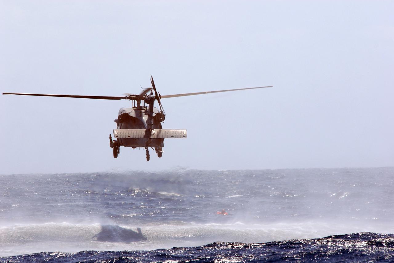 CAPE CANAVERAL, Fla. -- In a training exercise, known as Mode VIII, off Florida's central east coast, an HH-60G helicopter executes a rescue maneuver of a participant. In support of, and with logistical support from, NASA, USSTRATCOM is hosting a major exercise involving Department of Defense, Department of Homeland Security, search and rescue (SAR) forces, including the 45th Space Wing at Patrick Air Force Base, which support space shuttle astronaut bailout contingency operations, known as Mode VIII. This exercise tests SAR capabilities to locate, recover and provide medical treatment for astronauts following a space shuttle launch phase open-ocean bailout. Participants include members of the U.S. Navy, U.S. Coast Guard, U.S. Air Force, and NASA's Kennedy Space Center and Johnson Space Center. Photo credit: NASA/Dimitri Gerondidakis