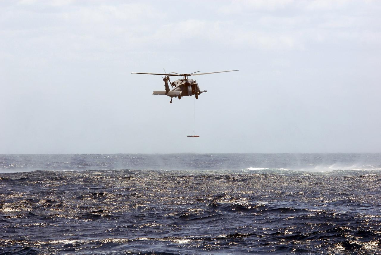 CAPE CANAVERAL, Fla. -- In a training exercise, known as Mode VIII, off Florida's central east coast, an HH-60G helicopter rescues a participant from the Atlantic Ocean. In support of, and with logistical support from, NASA, USSTRATCOM is hosting a major exercise involving Department of Defense, Department of Homeland Security, search and rescue (SAR) forces, including the 45th Space Wing at Patrick Air Force Base, which support space shuttle astronaut bailout contingency operations, known as Mode VIII.  This exercise tests SAR capabilities to locate, recover and provide medical treatment for astronauts following a space shuttle launch phase open-ocean bailout. Participants include members of the U.S. Navy, U.S. Coast Guard, U.S. Air Force, and NASA's Kennedy Space Center and Johnson Space Center.  Photo credit: NASA/Dimitri Gerondidakis