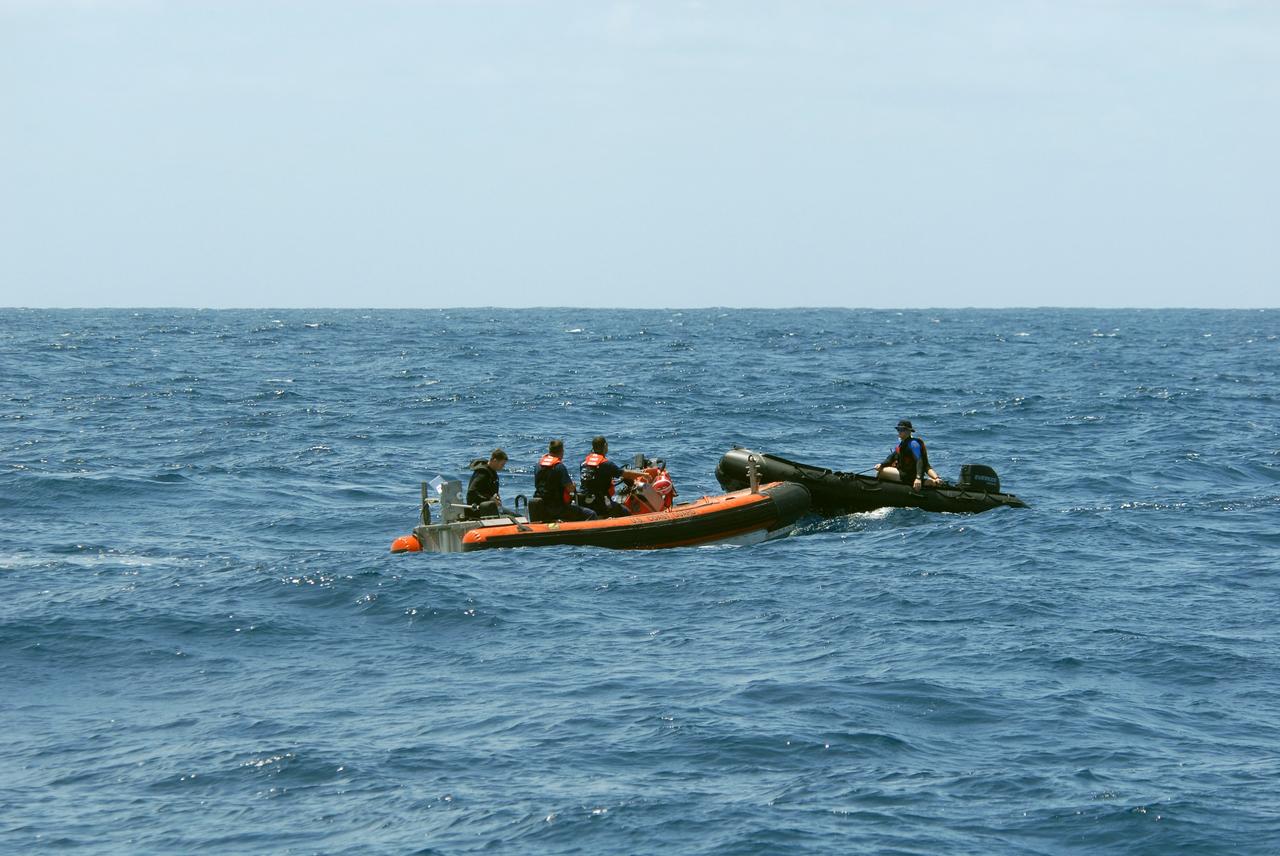 CAPE CANAVERAL, Fla. -- Support boats connect off Florida's central east coast during a rescue training exercise, known as Mode VIII. In support of, and with logistical support from, NASA, USSTRATCOM is hosting a major exercise involving Department of Defense, Department of Homeland Security, search and rescue (SAR) forces, including the 45th Space Wing at Patrick Air Force Base, which support space shuttle astronaut bailout contingency operations, known as Mode VIII. This exercise tests SAR capabilities to locate, recover and provide medical treatment for astronauts following a space shuttle launch phase open-ocean bailout. Participants include members of the U.S. Navy, U.S. Coast Guard, U.S. Air Force, and NASA's Kennedy Space Center and Johnson Space Center. Photo credit: NASA/Dimitri Gerondidakis