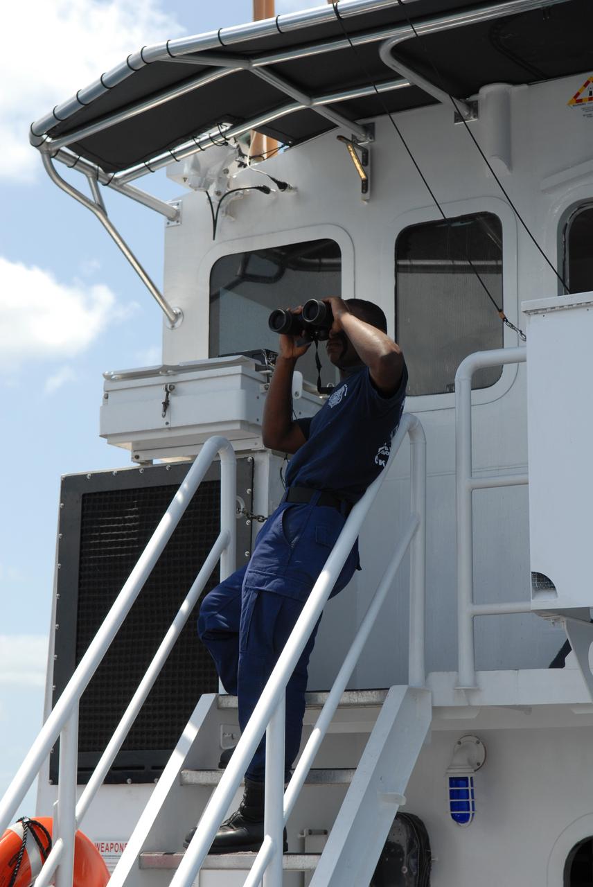 CAPE CANAVERAL, Fla. -- Off Florida's central east coast, a member of the rescue team in a training exercise, known as Mode VIII, keeps watch for the returning support crew from the U.S. Coast Guard cutter Kingfisher, from Port Canaveral, Fla. In support of, and with logistical support from, NASA, USSTRATCOM is hosting a major exercise involving Department of Defense, Department of Homeland Security, search and rescue (SAR) forces, including the 45th Space Wing at Patrick Air Force Base, which support space shuttle astronaut bailout contingency operations, known as Mode VIII. This exercise tests SAR capabilities to locate, recover and provide medical treatment for astronauts following a space shuttle launch phase open-ocean bailout. Participants include members of the U.S. Navy, U.S. Coast Guard, U.S. Air Force, and NASA's Kennedy Space Center and Johnson Space Center. Photo credit: NASA/Dimitri Gerondidakis