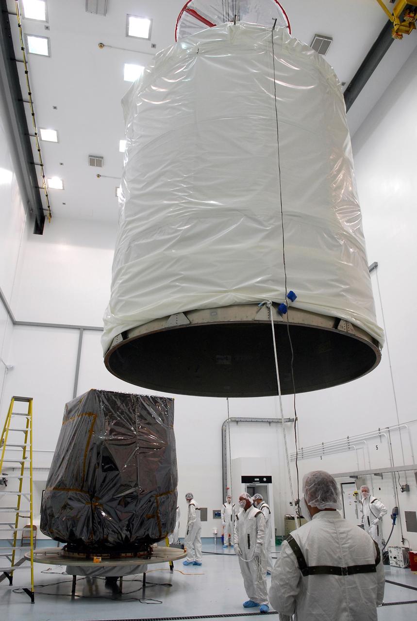 CAPE CANAVERAL, Fla. --   At Astrotech in Titusville, Fla., the payload transportation canister is lifted so it can be installed over the GLAST spacecraft, behind it.  After installation, the spacecraft will be moved to pad 17-B at Cape Canaveral Air Force Station.  At the pad, NASA's Gamma-Ray Large Area Space Telescope will be lifted into the mobile service tower and encapsulated in the fairing for launch.  GLAST  is a powerful space observatory that will explore the Universe's ultimate frontier, where nature harnesses forces and energies far beyond anything possible on Earth;  probe some of science's deepest questions, such as what our Universe is made of, and search for new laws of physics; explain how black holes accelerate jets of material to nearly light speed; and help crack the mystery of stupendously powerful explosions known as gamma-ray bursts. The launch date is targeted no earlier than June 3.   Photo credit: NASA/Kim Shiflett