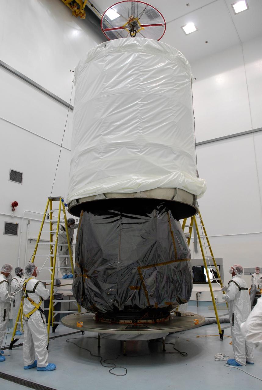 CAPE CANAVERAL, Fla. --  At Astrotech in Titusville, Fla., the payload transportation canister is lowered over the GLAST spacecraft for installation. The spacecraft will be moved to pad 17-B at Cape Canaveral Air Force Station. At the pad, NASA's Gamma-Ray Large Area Space Telescope will be lifted into the mobile service tower and encapsulated in the fairing for launch.  GLAST  is a powerful space observatory that will explore the Universe's ultimate frontier, where nature harnesses forces and energies far beyond anything possible on Earth;  probe some of science's deepest questions, such as what our Universe is made of, and search for new laws of physics; explain how black holes accelerate jets of material to nearly light speed; and help crack the mystery of stupendously powerful explosions known as gamma-ray bursts. The launch date is targeted no earlier than June 3.   Photo credit: NASA/Kim Shiflett