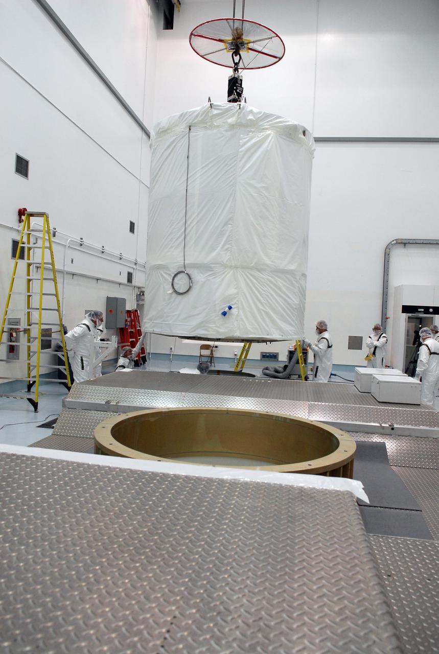 CAPE CANAVERAL, Fla. --  At Astrotech in Titusville, Fla., an overhead crane moves the GLAST spacecraft, inside its payload transportation canister, to the waiting transporter for transfer to pad 17-B at Cape Canaveral Air Force Station. At the pad, NASA's Gamma-Ray Large Area Space Telescope will be lifted into the mobile service tower and encapsulated in the fairing for launch.  GLAST  is a powerful space observatory that will explore the Universe's ultimate frontier, where nature harnesses forces and energies far beyond anything possible on Earth;  probe some of science's deepest questions, such as what our Universe is made of, and search for new laws of physics; explain how black holes accelerate jets of material to nearly light speed; and help crack the mystery of stupendously powerful explosions known as gamma-ray bursts. The launch date is targeted no earlier than June 3.   Photo credit: NASA/Kim Shiflett