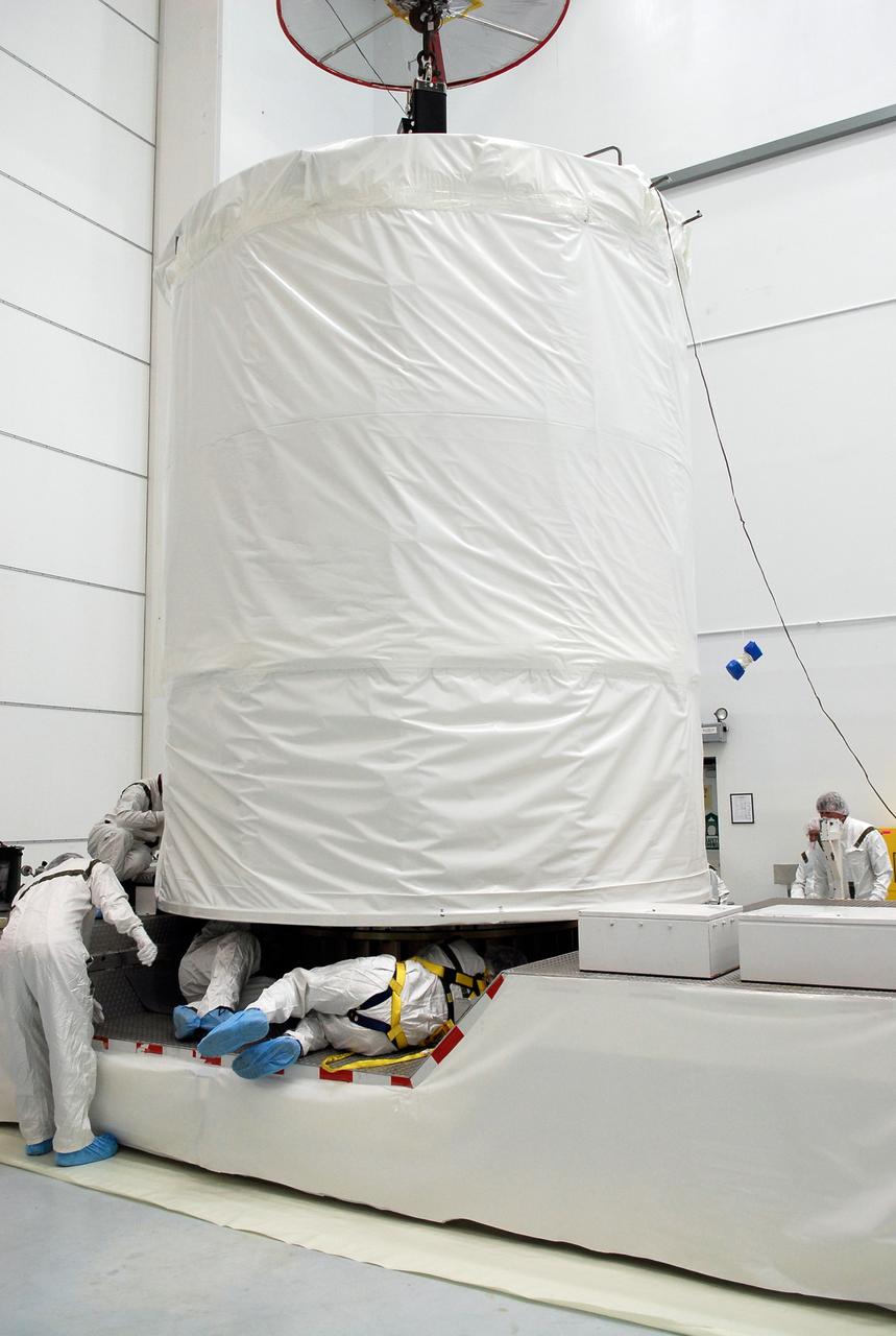 CAPE CANAVERAL, Fla. --  At Astrotech in Titusville, Fla., technicians secure the GLAST spacecraft, inside its payload transportation canister, to the transporter for transfer to pad 17-B at Cape Canaveral Air Force Station. At the pad, NASA's Gamma-Ray Large Area Space Telescope will be lifted into the mobile service tower and encapsulated in the fairing for launch.  GLAST  is a powerful space observatory that will explore the Universe's ultimate frontier, where nature harnesses forces and energies far beyond anything possible on Earth;  probe some of science's deepest questions, such as what our Universe is made of, and search for new laws of physics; explain how black holes accelerate jets of material to nearly light speed; and help crack the mystery of stupendously powerful explosions known as gamma-ray bursts. The launch date is targeted no earlier than June 3.   Photo credit: NASA/Kim Shiflett