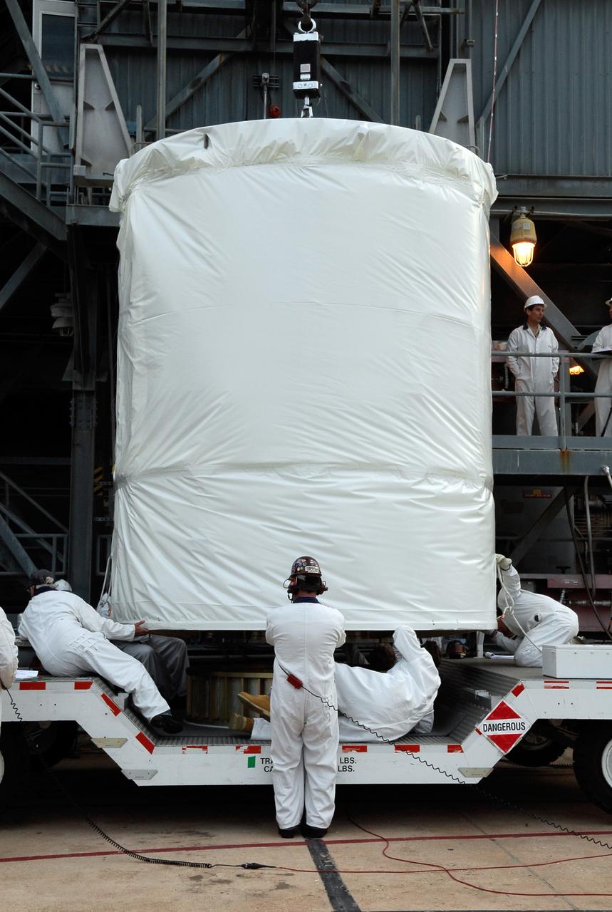 CAPE CANAVERAL, Fla. --  At pad 17-B at Cape Canaveral Air Force Station, workers secure the lines of the hoist that will lift the GLAST spacecraft into the mobile service tower.  In the tower, GLAST will be mated with the Delta II second stage.  GLAST  is a powerful space observatory that will explore the Universe's ultimate frontier, where nature harnesses forces and energies far beyond anything possible on Earth;  probe some of science's deepest questions, such as what our Universe is made of, and search for new laws of physics; explain how black holes accelerate jets of material to nearly light speed; and help crack the mystery of stupendously powerful explosions known as gamma-ray bursts. The launch date is targeted no earlier than June 3.   Photo credit: NASA/Kim Shiflett
