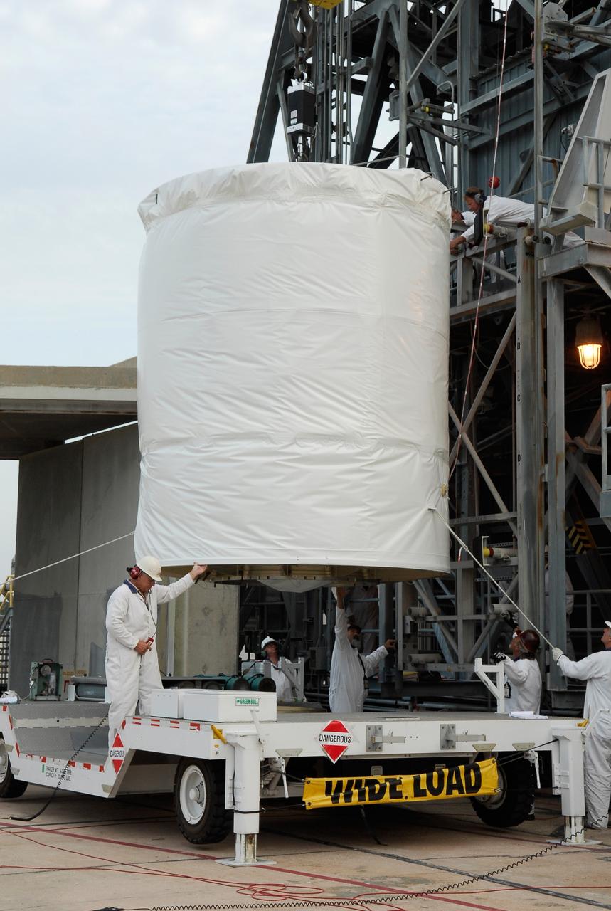 CAPE CANAVERAL, Fla. --  At pad 17-B at Cape Canaveral Air Force Station, workers help stabilize the ascent of the GLAST spacecraft into the mobile service tower.  In the tower, GLAST will be mated with the Delta II second stage.  GLAST  is a powerful space observatory that will explore the Universe's ultimate frontier, where nature harnesses forces and energies far beyond anything possible on Earth;  probe some of science's deepest questions, such as what our Universe is made of, and search for new laws of physics; explain how black holes accelerate jets of material to nearly light speed; and help crack the mystery of stupendously powerful explosions known as gamma-ray bursts. The launch date is targeted no earlier than June 3.   Photo credit: NASA/Kim Shiflett