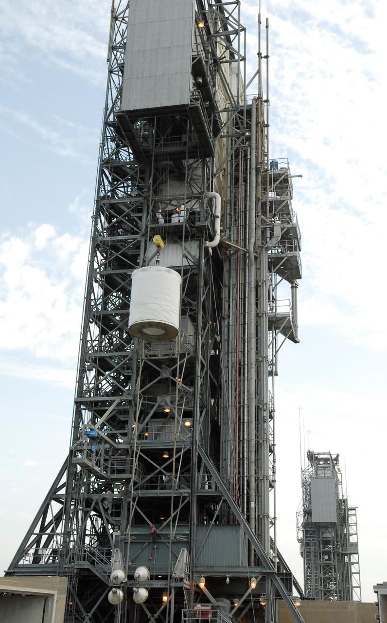 CAPE CANAVERAL, Fla. --  At pad 17-B at Cape Canaveral Air Force Station, the GLAST spacecraft continues its rise toward the upper level of the mobile service tower.  In the tower, GLAST will be mated with the Delta II second stage.  GLAST  is a powerful space observatory that will explore the Universe's ultimate frontier, where nature harnesses forces and energies far beyond anything possible on Earth;  probe some of science's deepest questions, such as what our Universe is made of, and search for new laws of physics; explain how black holes accelerate jets of material to nearly light speed; and help crack the mystery of stupendously powerful explosions known as gamma-ray bursts. The launch date is targeted no earlier than June 3.   Photo credit: NASA/Kim Shiflett