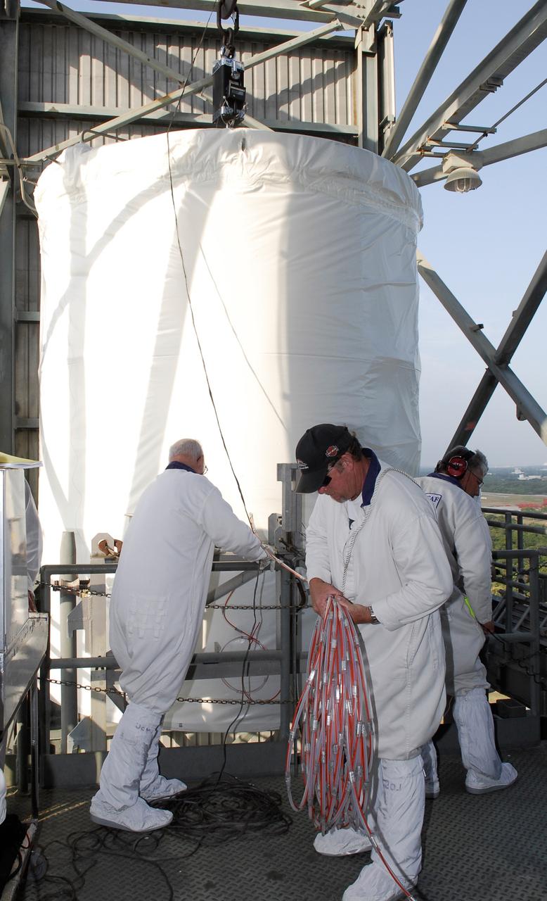 CAPE CANAVERAL, Fla. --  At pad 17-B at Cape Canaveral Air Force Station, workers prepare to move the GLAST spacecraft into the mobile service tower.  In the tower, GLAST will be mated with the Delta II second stage.  GLAST  is a powerful space observatory that will explore the Universe's ultimate frontier, where nature harnesses forces and energies far beyond anything possible on Earth;  probe some of science's deepest questions, such as what our Universe is made of, and search for new laws of physics; explain how black holes accelerate jets of material to nearly light speed; and help crack the mystery of stupendously powerful explosions known as gamma-ray bursts. The launch date is targeted no earlier than June 3.   Photo credit: NASA/Kim Shiflett