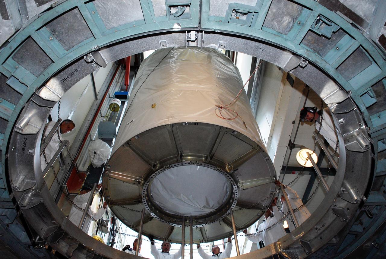 CAPE CANAVERAL, Fla. --  At pad 17-B at Cape Canaveral Air Force Station, workers begin lowering the GLAST spacecraft into the opening above the Delta II second stage in the mobile service tower.  GLAST will be mated with the Delta II second stage.  GLAST  is a powerful space observatory that will explore the Universe's ultimate frontier, where nature harnesses forces and energies far beyond anything possible on Earth;  probe some of science's deepest questions, such as what our Universe is made of, and search for new laws of physics; explain how black holes accelerate jets of material to nearly light speed; and help crack the mystery of stupendously powerful explosions known as gamma-ray bursts. The launch date is targeted no earlier than June 3.   Photo credit: NASA/Kim Shiflett