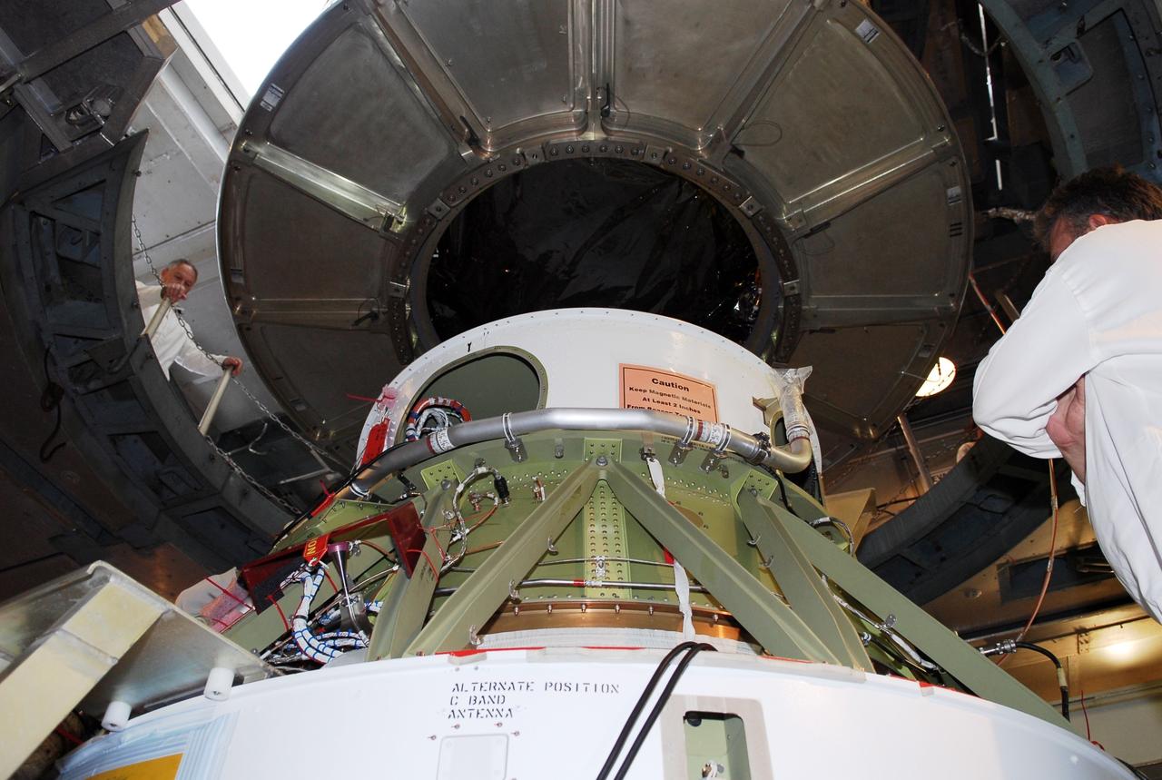 CAPE CANAVERAL, Fla. --   At pad 17-B at Cape Canaveral Air Force Station, the GLAST spacecraft is lowered onto the Delta II second stage in the mobile service tower.  GLAST will be mated with the Delta II second stage.  GLAST  is a powerful space observatory that will explore the Universe's ultimate frontier, where nature harnesses forces and energies far beyond anything possible on Earth;  probe some of science's deepest questions, such as what our Universe is made of, and search for new laws of physics; explain how black holes accelerate jets of material to nearly light speed; and help crack the mystery of stupendously powerful explosions known as gamma-ray bursts. The launch date is targeted no earlier than June 3.   Photo credit: NASA/Kim Shiflett