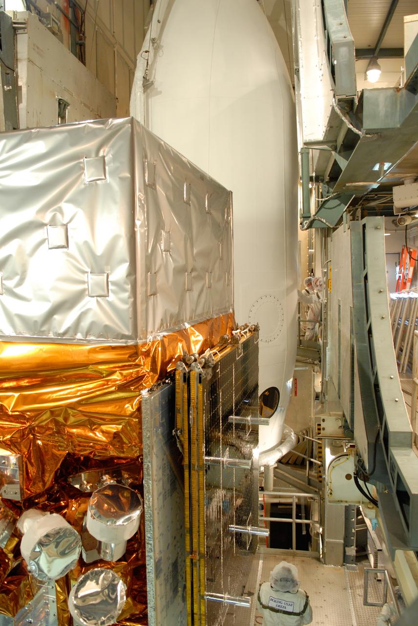 CAPE CANAVERAL, Fla. --  Inside the mobile service tower on Launch Pad 17-B at Cape Canaveral Air Force Station, NASA's Gamma-Ray Large Area Space Telescope, or GLAST, is ready for encapsulation in the payload fairing, which is seen behind it. The fairing is a molded structure that fits flush with the outside surface of the Delta II upper stage booster and forms an aerodynamically smooth nose cone, protecting the spacecraft during launch and ascent. GLAST  is a powerful space observatory that will explore the Universe's ultimate frontier, where nature harnesses forces and energies far beyond anything possible on Earth;  probe some of science's deepest questions, such as what our Universe is made of, and search for new laws of physics; explain how black holes accelerate jets of material to nearly light speed; and help crack the mystery of stupendously powerful explosions known as gamma-ray bursts. The launch date is targeted no earlier than June 3. Photo credit: NASA/Jim Grossmann