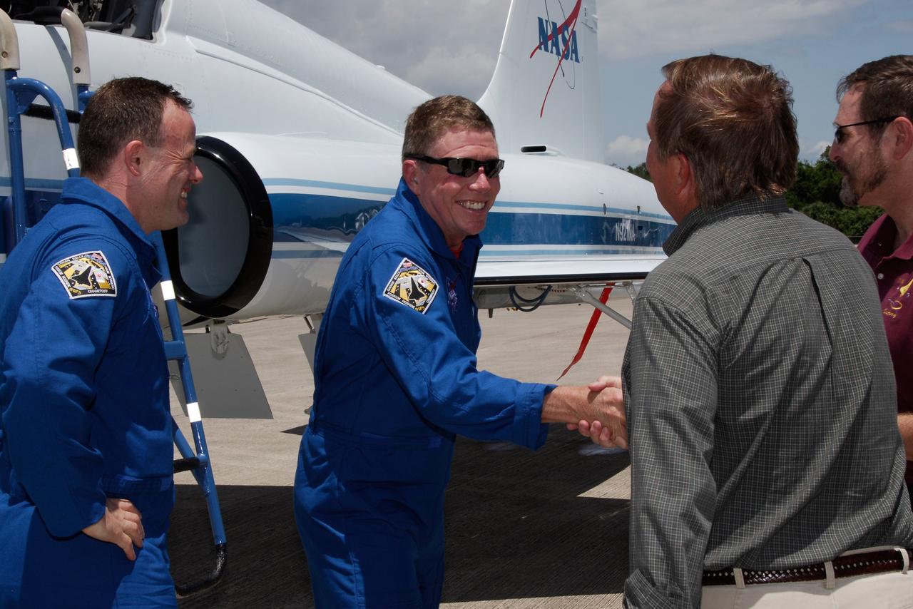CAPE CANAVERAL, Fla. --  The crew of space shuttle Discovery's STS-124 mission arrives at the Shuttle Landing Facility at NASA's Kennedy Space Center aboard T-38 jet trainers to get ready for launch.  From left, Mission Specialists Ron Garan and Mike Fossum are greeted by Shuttle Launch Director Mike Leinbach  and the director of Launch Vehicle Processing, Mike Wetmore.  Launch of Discovery is scheduled for 5:02 p.m. May 31.  On the STS-124 mission, the crew of seven will deliver and install the Japanese Experiment Module – Pressurized Module and Japanese Remote Manipulator System.  Photo credit: NASA/Kim Shiflett